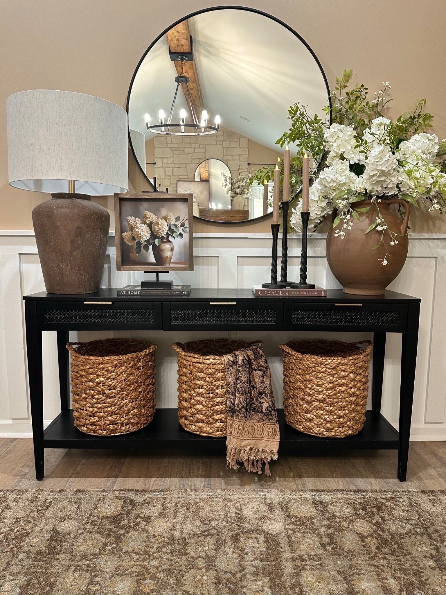 🍃Spring Console Refresh. Follow @farmtotablecreations on Instagram for more inspiration.

Throwing it back to when I gave my console a mid-spring refresh and I’m still totally swooning over this gorgeous artwork my sweet friend Brittany @currentlychic helped me create. It’s a stunning blend of hydrangeas and eucalyptus elegantly displayed in a vintage distressed vase. The combination of stems cascade graciously over the edges, and the backdrop is a neutral blend of colors. Shown here in size 12x12 featuring Briarsmoke stain. Be sure to use my code FARMTOTABLE for 15% off.

‼️ For Reference:
7 hydrangeas stems shown in vase.
1 set/2 greenery
12x12  artwork with Briarsmoke stain. Use code FARMTOTABLE for 15% off.
Wall color is Beach House by Sherwin Williams.‼️

Spring Art | Loloi Rugs | console table | console table styling | faux stems | entryway space | home decor finds | neutral decor | entryway decor | cozy home | affordable decor | home decor | home inspiration | spring stems | spring console | spring vignette | spring decor | spring decorations | console styling | entryway rug | cozy moody home | moody decor | neutral home

#LTKHome #LTKSaleAlert