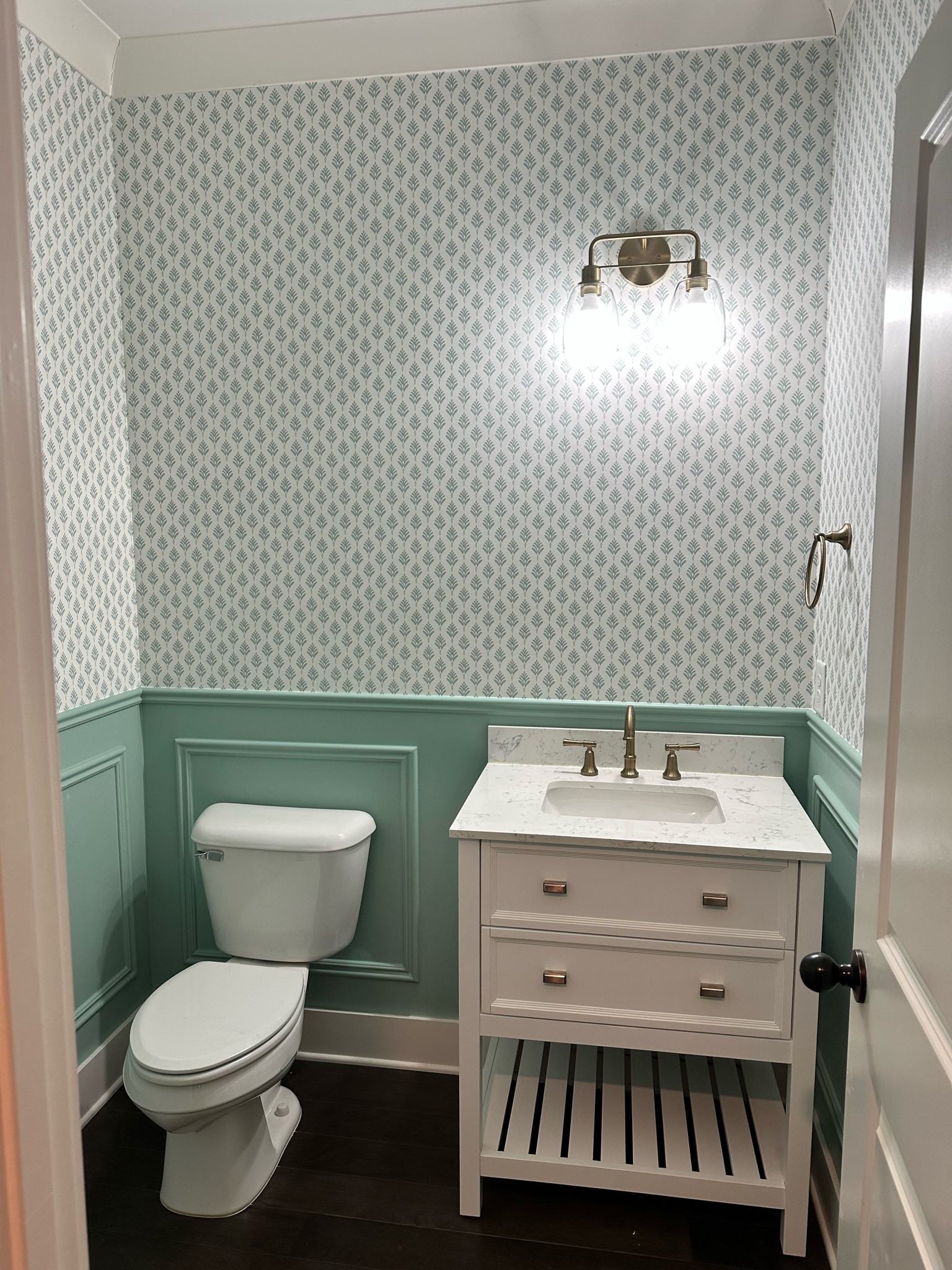 York French Scallop Wallpaper in the color Vertigris (teal blue) and white vanity with gold fixtures!