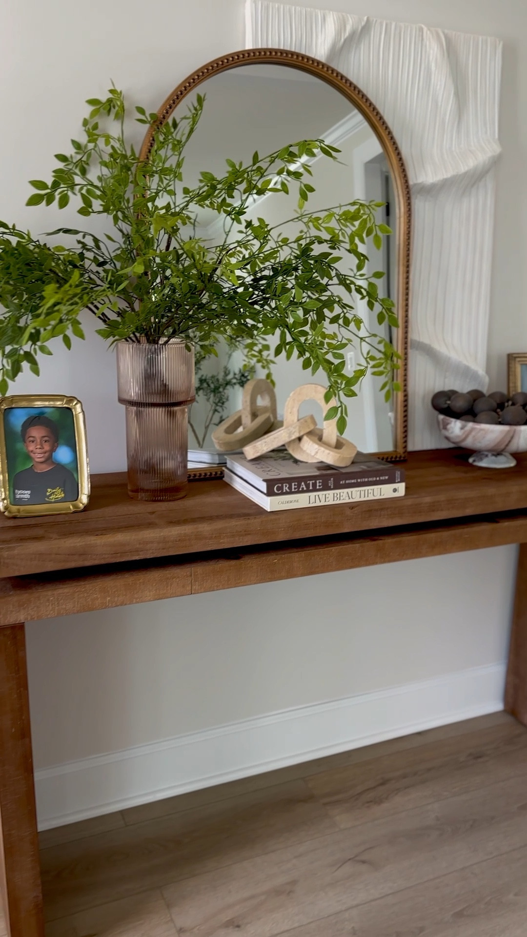 OBSESSED with my entryway table! It’s so simple but at the same time sooo unique! The beaded arch mirror takes it to another level, my fave amber vase with these lush green stems and the marble catch all is everything! 

#LTKHome