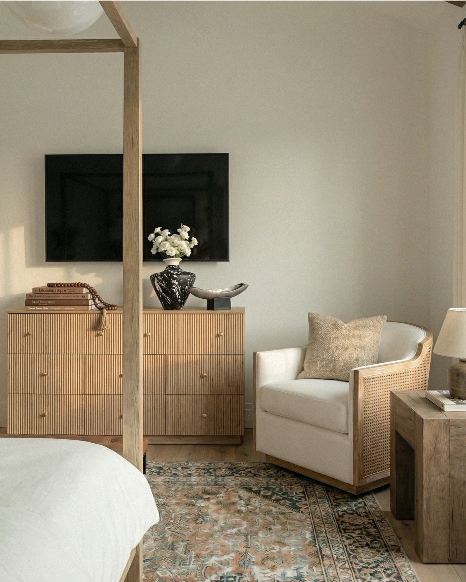 Shop the look:
* Wood canopy bed 
* Brown leather upholstered bench
* Brown knitted blanket
* Brown throw pillows
* Brown wood 3 drawer nightstands
* Wall art
* Glove wall lights
* White tree planter
* Black vase
* Black table lamp
* White decor bowl
* Decor books
* Wood dresser
* Brown traditional rug 
* Wood decor beads
* Wood upholstered swivel chair
* Wood end table
* Green runner rug 
* Faux olive tree

#LTKsale #LTKhome #LTKstyletip