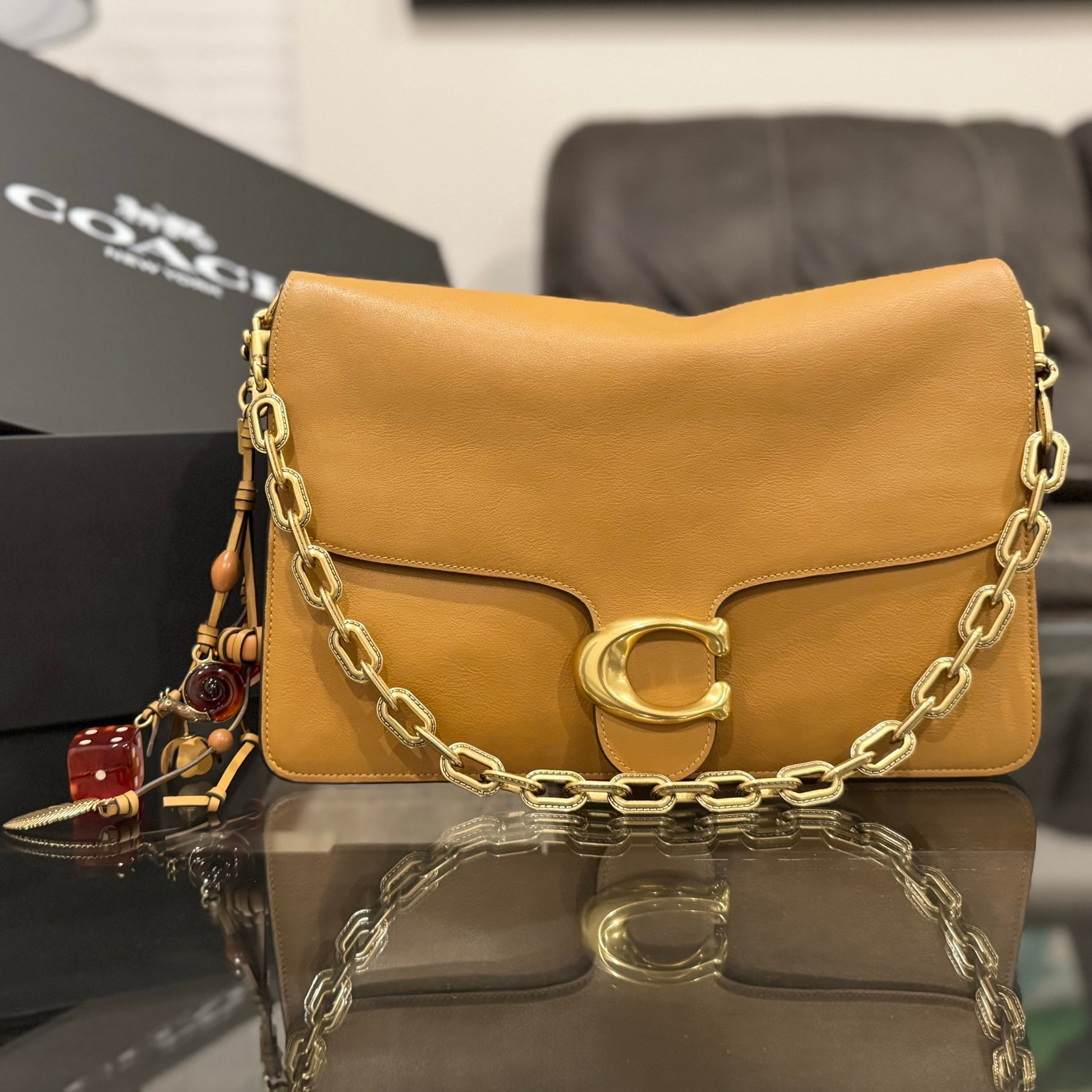The Coach Chain Tabby 35 in Honey Brown is that girl. The rich leather, the oversized chain—she’s bringing all the luxe vibes! And this Cluster Charm? The perfect finishing touch! 🤎✨ #Coach #ChainTabby35 

#LTKStyleTip #LTKItBag