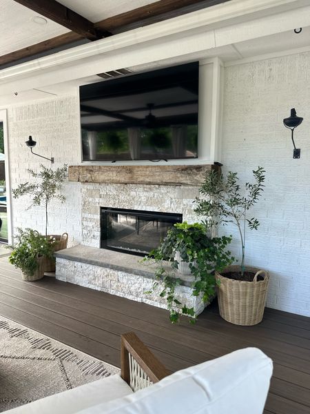 Outdoor fireplace. Faux stone veneer. Outdoor lanterns! Amazon finds. Patio. Deck. Porch. Neutral earthy vibes. Planters are plastic and from ikea! 

#LTKSeasonal #LTKhome