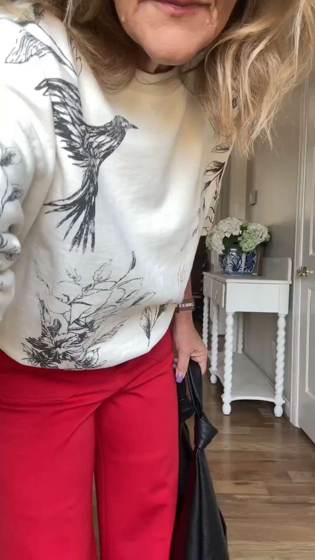 The Colette pant at Anthro is a staple in my closet. I've picked up a couple new pair for fall.  Love the red in a knit fabric. Wearing size 29 petite.

Graphic sweatshirt in a french terry. Size medium.
Oversized knot slouch bag and dolce vita sneakers are pieces I've had in my closet for a year now. They finish the outfit perfectly. 

 #LTKOver40 #LTKPetite #LTKTravel