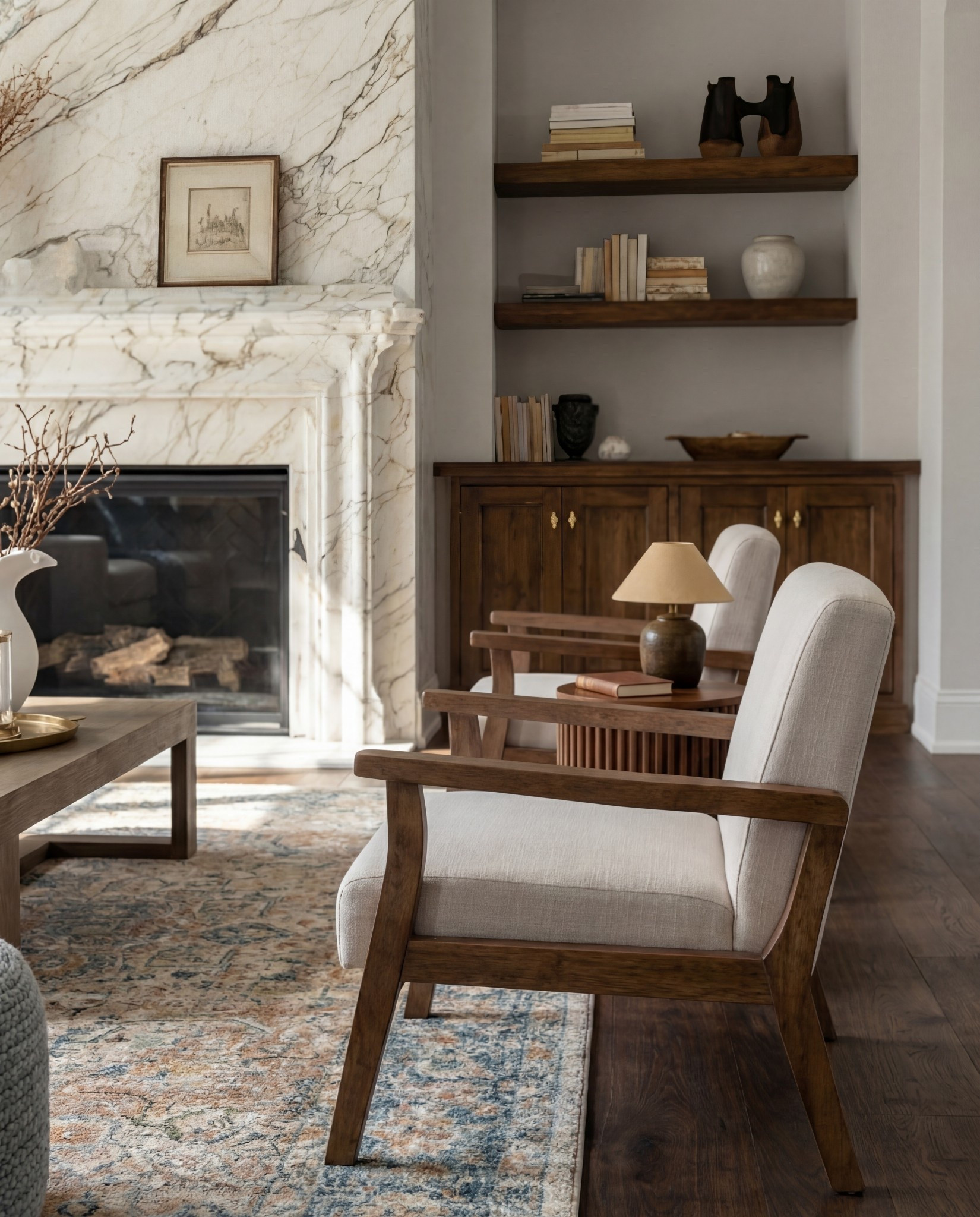 Shop the Look:
• Cream upholstered sofa
• Blue knit throw blanket
• Blue textured throw pillows
• Round knit ottomans
• Wood armchairs with cream cushions
• Marble fireplace surround
• Wood coffee table
• Ribbed wood side tables
• Neutral patterned area rug
• Ceramic vases + candle set

#LTKHome #LTKSaleAlert #LTKFindsUnder100