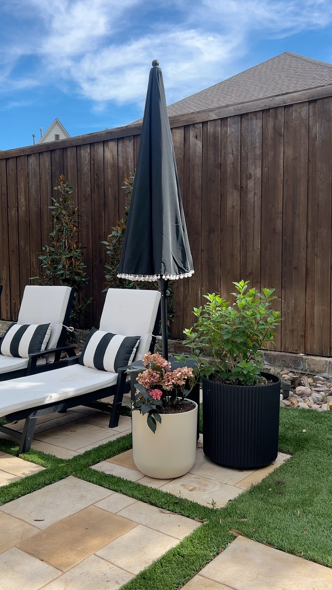 This little patio refresh made such a difference. The black and white loungers feel clean and classic, and I love how the oversized planters add height and texture. The umbrella ties everything together and makes it feel like a true outdoor retreat. Simple updates, big impact.

backyard patio ideas, outdoor lounge chairs, black and white patio decor, modern backyard styling, outdoor planters, patio refresh, affordable outdoor makeover

#LTKdayinmylife #LTKSeasonal #LTKHome