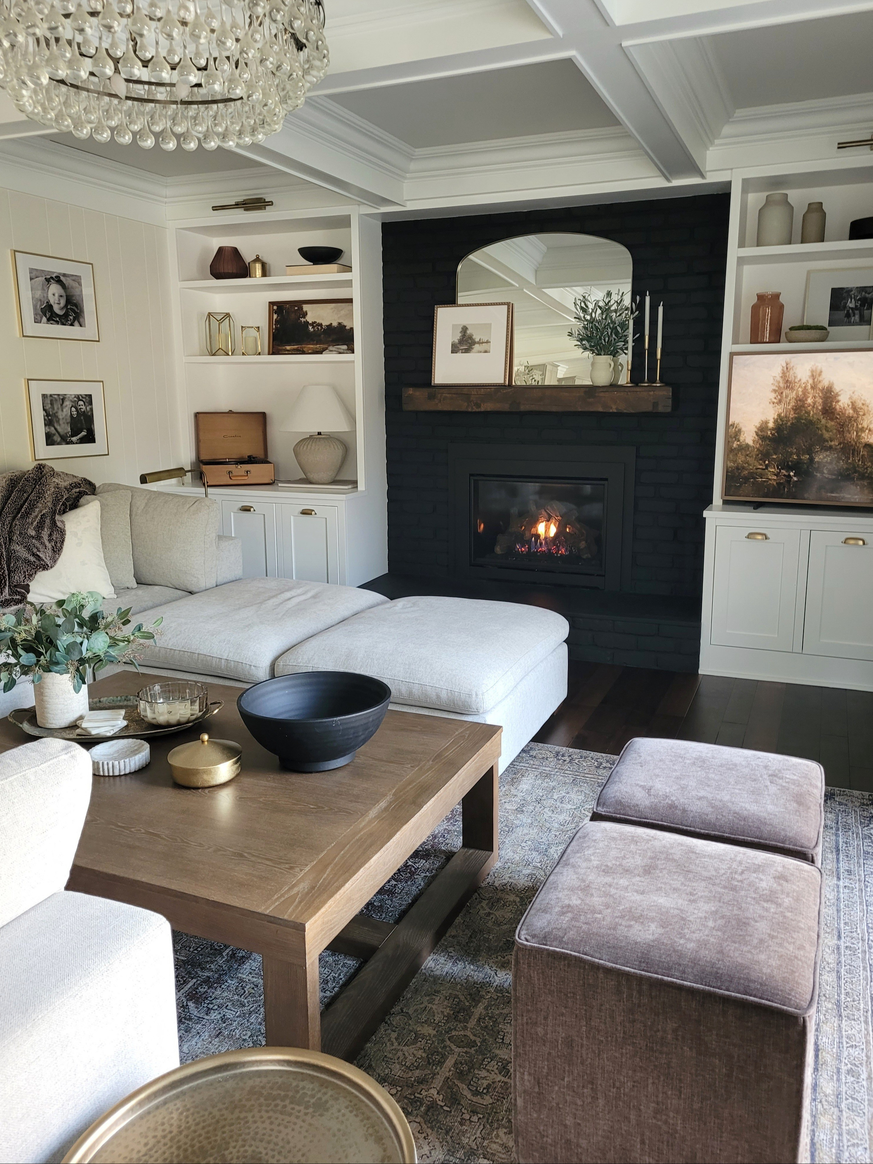Living room family room inspo - affordable coffee table with our sectional sofa and cube ottomans. Built in styling,  shelf styling, mantle decor,  black fireplace,  fireplace decor,  mantle styling,  coffee table styling, vintage inspired rug,  neutral rug

#LTKHome #LTKStyleTip