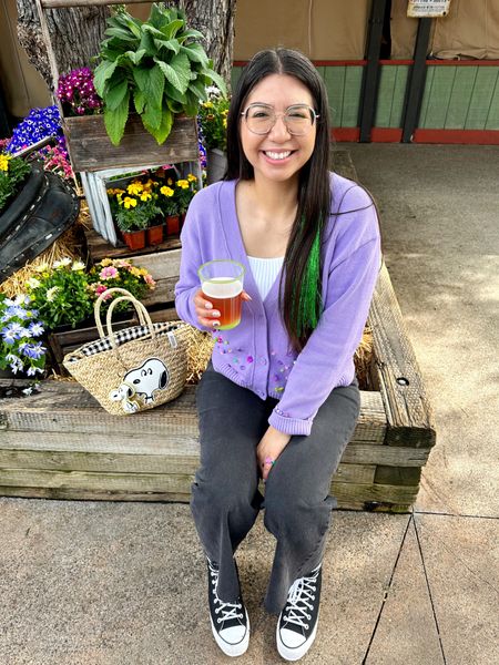 Outfit of the day for the Knott’s Berry Farm Boysenberry Festival. I picked up this purple sweater from Amazon and sewed on some colorful beads. And then I added in green tinsel extensions for a little extra fun. The Snoopy purse is from Zara a few years ago. #campsnoopy #knotts #snoopy #knottsberryfarm #boysenberryfestivaloutfit #knottsoutfit #amazonbasics #purplesweater 