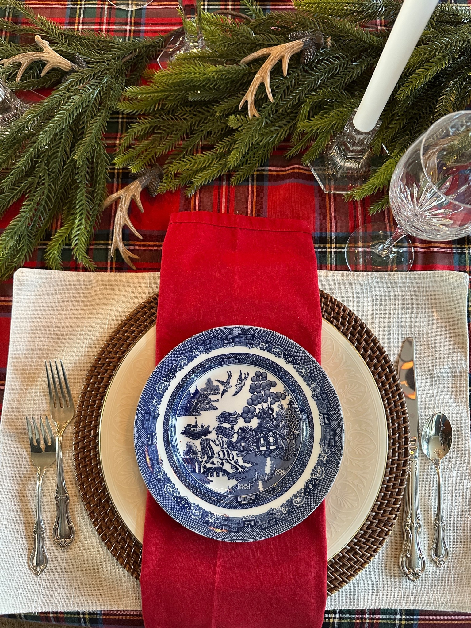 Christmas tablescape with a Ralph Lauren Christmas vibe. Blue willow plates and red napkins with a red plaid tablecloth.

#LTKHoliday #LTKSeasonal #LTKHome