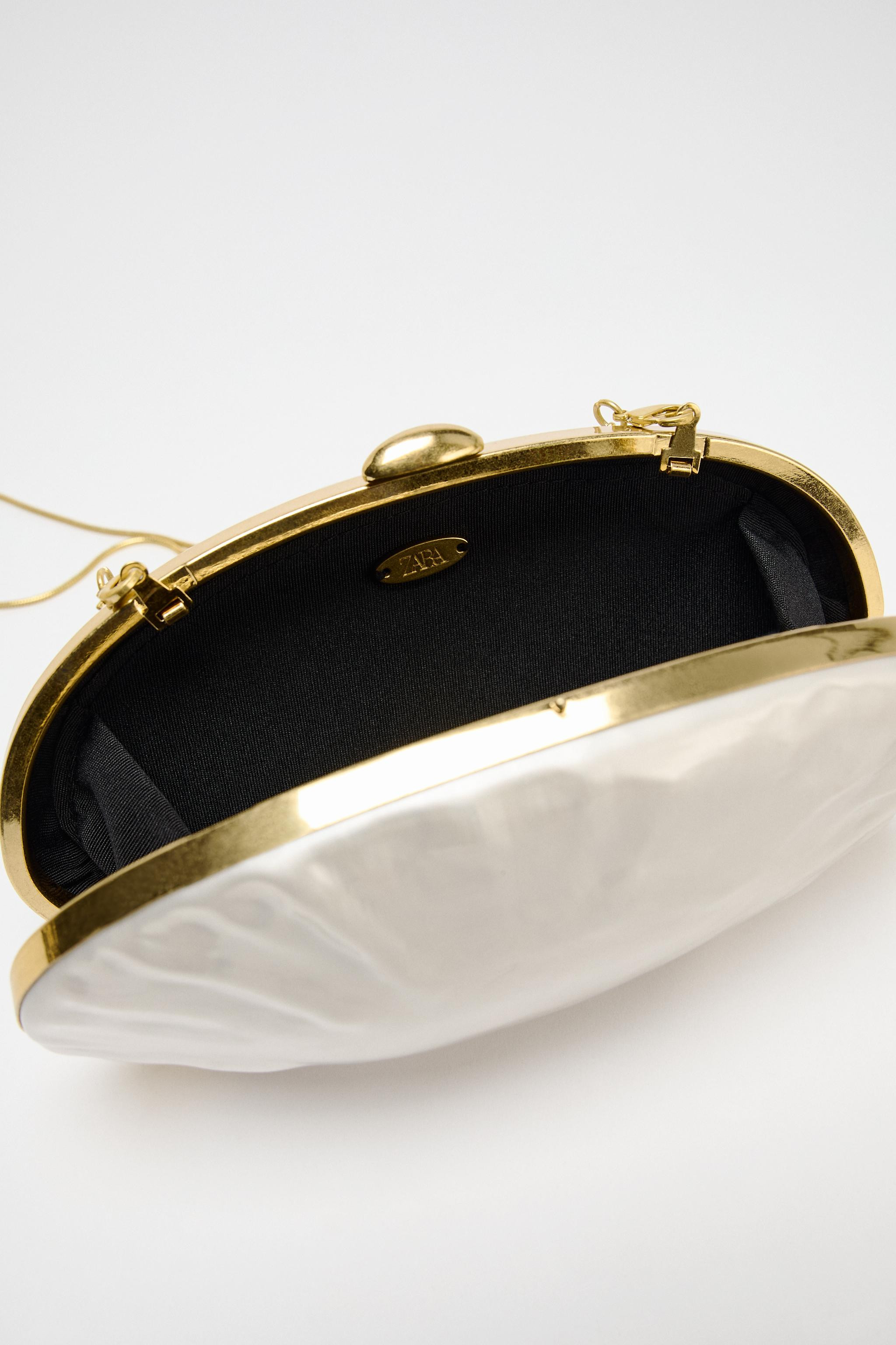 Rigid elongated purl effect clutch bag. Metallic sides. Detachable chain strap. Metal clasp closu... | Zara UK