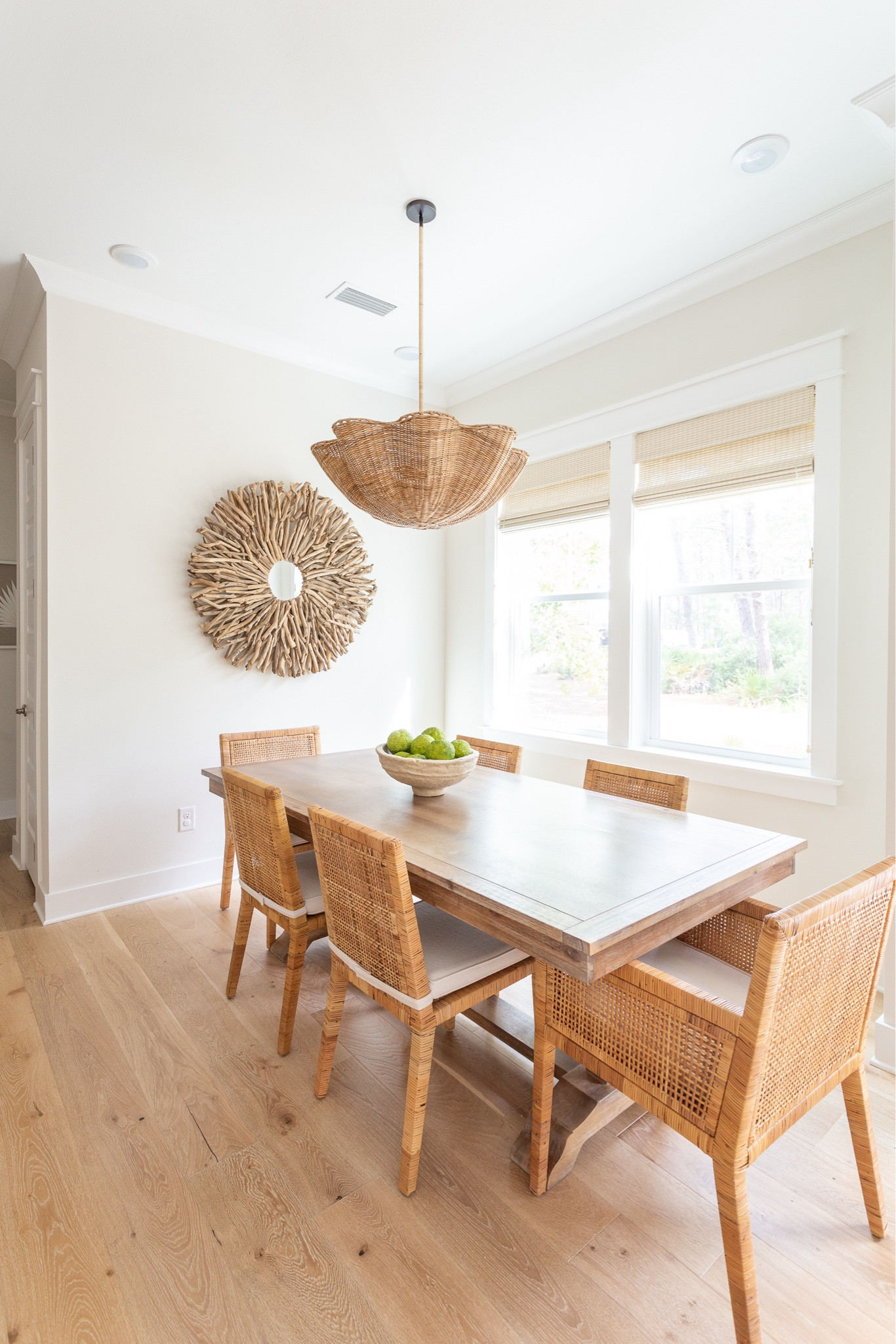 HOLA BEACHES CASITA DINING ROOM - The dining room at Hola Beaches Casita has a scalloped wicker chandelier, woven dining chairs, a light wood dining table and a driftwood mirror. See more of the space and the 30A rental home here: https://lifeonvirginiastreet.com/hola-beaches-casita-30a-tour.
.
#ltkhome #ltksalealert #ltkseasonal #ltkstyletip #ltkfindsunder100 #ltkfindsunder50

#LTKSaleAlert #LTKHome #LTKSeasonal