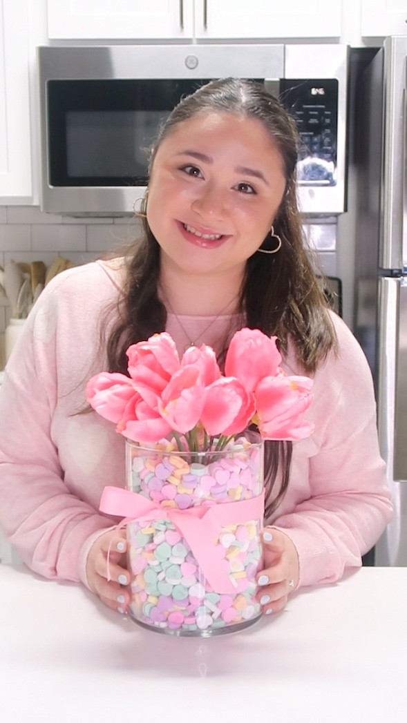DIY Valentine’s Day Centerpiece 🩷💐

All you need is a wide cylinder vase, a glass to put in the middle, 4-5 bags of candy hearts, flowers (fake or real.. I used fake), and some ribbon. 🎀 

This is such a simple DIY to make and it’ll look so cute in your counter or mantle! 

#valentinesday #valentinesdaydiy #homedecor #vday #vdaygifts #valentinesgift #valentinesdecor #diyvalentines #diygift #valentineflowers #valentinescrafts #diycraft #giftideas #reels #lndshop #comingsoon #valentinesday
