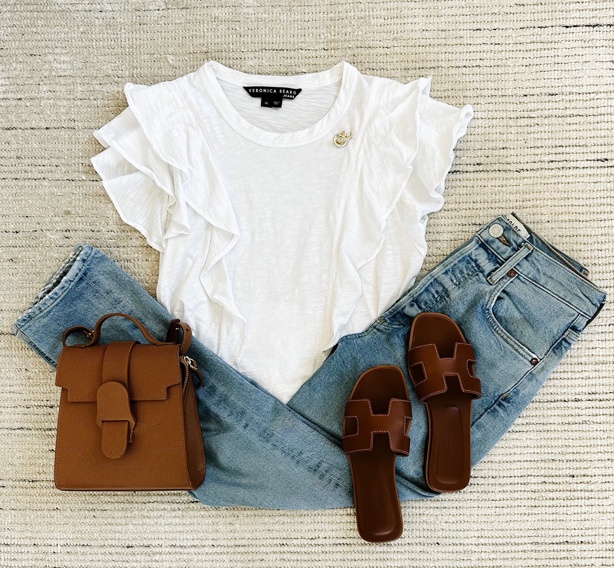 Spring casual outfit with ruffle short sleeve top and my all-time favorite Agolde jeans! Would definitely size down a size on the bottoms. Paired with brown sandals and accessories for a classic look  

#LTKstyletip #LTKSeasonal