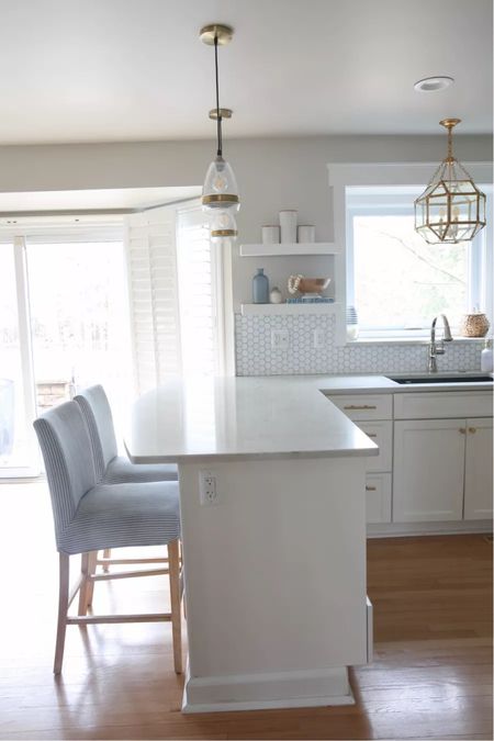 Love my Coastal kitchen! My coastal upholstered counter stools perfectly compliment my brass pendant lights and white kitchen! (5/16)

#LTKhome #LTKstyletip