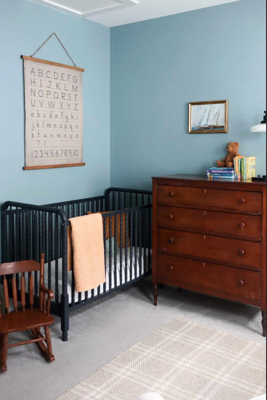 This vintage-inspired baby boy nursery proves that timeless doesn’t have to mean boring.✨ We started with soft blue walls and layered in warm wood tones, heirloom-style furniture, and classic touches like gingham textiles and turned-leg details. A mix of traditional patterns and collected artwork gives the space a cozy, storybook charm that feels both nostalgic and fresh. Thoughtful styling keeps it calm and inviting — a sweet retreat designed to grow with baby for years to come. 🍼💙 

 #vintagenursery #traditionalstyle #babyboynursery #LTKHome #LTKBaby #LTKFamily