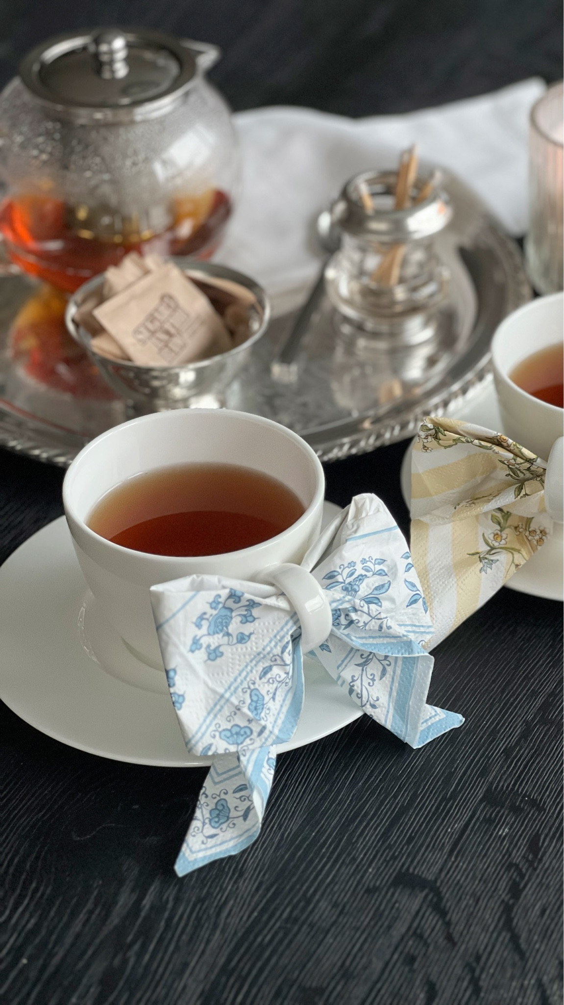 A simple paper napkin, styled into an elevated detail for a modern tea moment at home.

Paper napkin styling, napkin bow fold, napkin fold ideas, tea cup styling, white teacups and saucers, modern tea setup, neutral tablescape, black wood table decor, hosting details, simple hosting ideas, Mother’s Day brunch ideas, tea party aesthetic modern, elevated hosting, small hosting details, affordable table styling, everyday hosting ideas, silver serving tray, glass teapot, loose leaf tea setup, candlelight hosting, minimalist tablescape, black and white decor, classic hosting pieces, modern hostess style

#LTKfoodie #LTKSeasonal #LTKHome