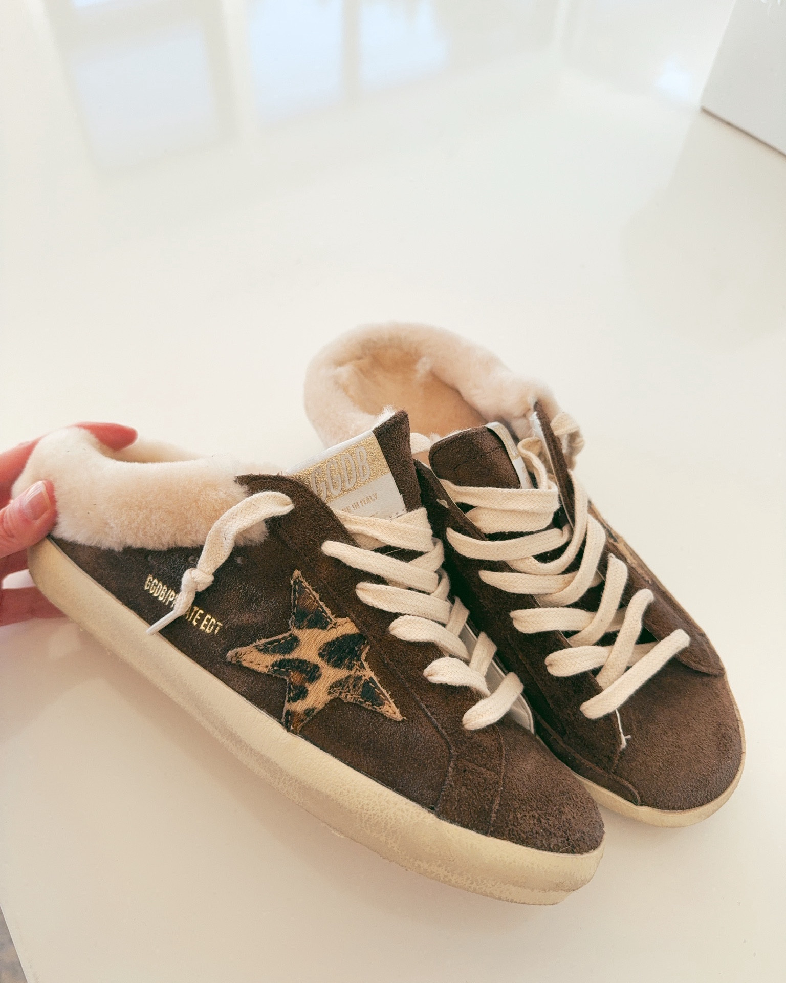These Golden Goose sneakers are SO cute! They are slip ons that are going to feel like cozy slippers with the soft shearling lined soles. Love the brown tones and leopard print accents too! 

#LTKSeasonal
