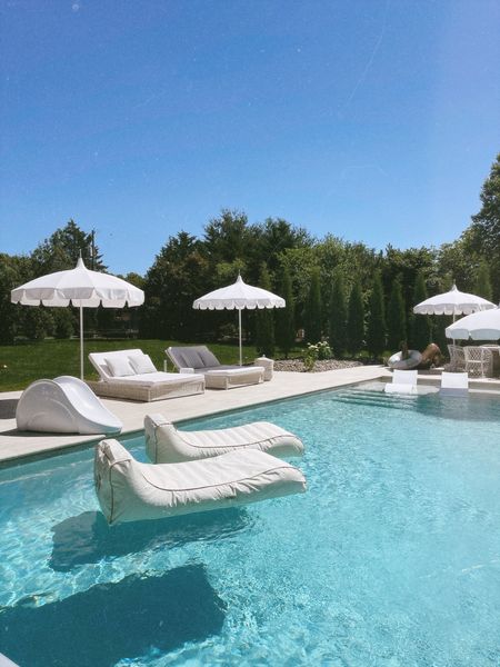 Pool floats and outdoor pool patio umbrella and chaises 