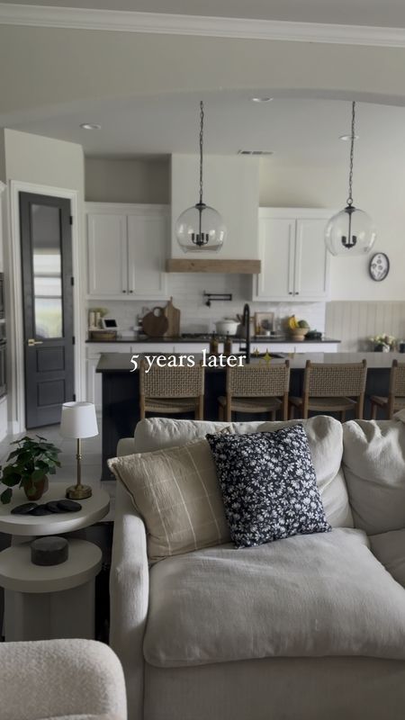 Living room and kitchen decor, open concept, kitchen island pendant lights, woven counter stools, Amazon throw pillows, Walmart side tables, round coffee table, neutral rug, wooden coffee tablee

#LTKHome