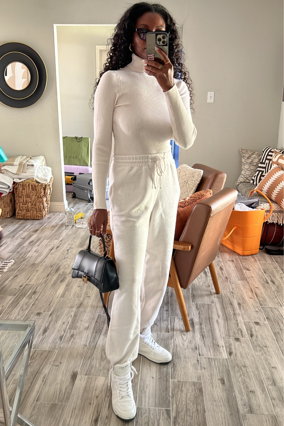 Neutral comfy outfit! Cream turtleneck bodysuit, cream sweatpants, white Prada sneakers and a black hourglass Balenciaga bag  

#LTKSale #LTKtravel #LTKunder100