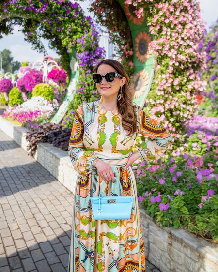 Packed this gorgeous printed maxi dress and blue handbag for our trip to Dubai. It runs true to size. Also, aren’t these sunglasses fun? The white trim around the lenses make them so unique. ✈️ 🕶️ 

#LTKSeasonal #LTKFind 

#LTKtravel #LTKstyletip #LTKitbag