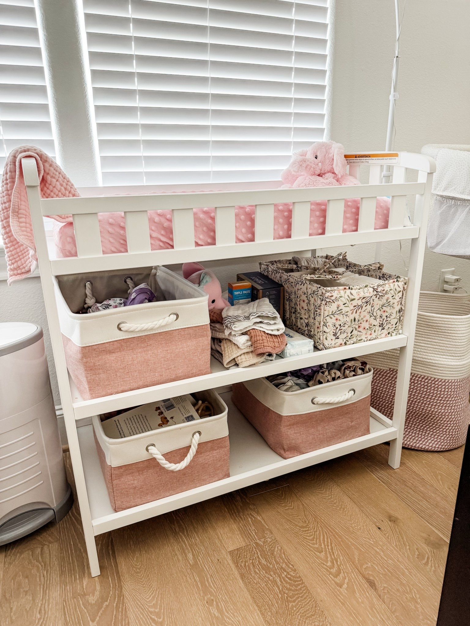 How I organized our baby girl’s space in our primary bedroom. Sharing a full nursery corner setup with a dual-purpose diaper changing table and dresser, bedside bassinet, cozy recliner chair for night feeds, laundry basket, and diaper pail. This functional newborn setup is perfect for small spaces, room sharing, and easy nighttime routines. Think practical baby organization, minimalist nursery ideas, and must-have newborn essentials all in one calm, elevated setup. 



#LTKHome #LTKKids #LTKBaby