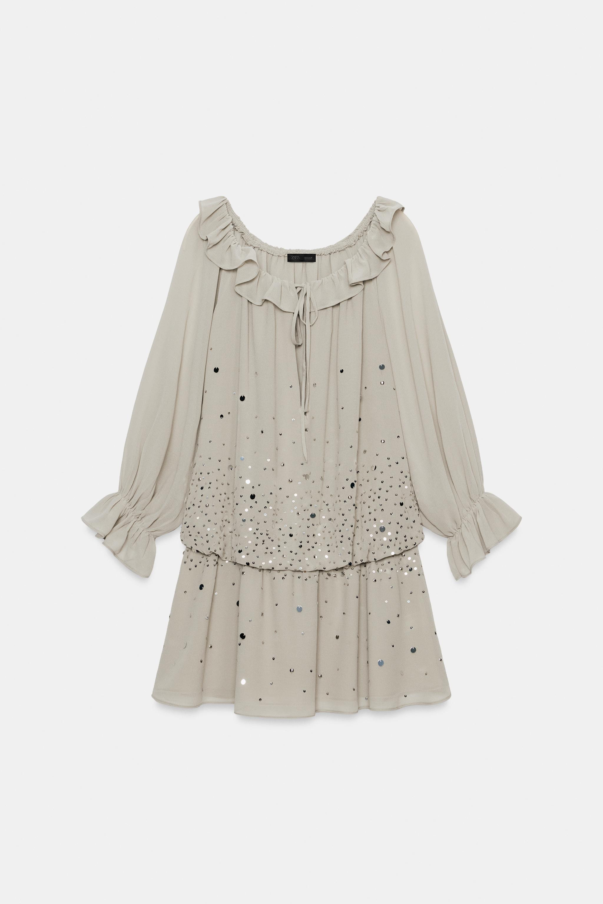 Model height: 181 cmMini dress with a round neckline, elasticated detail, opening and tie fasteni... | Zara UK