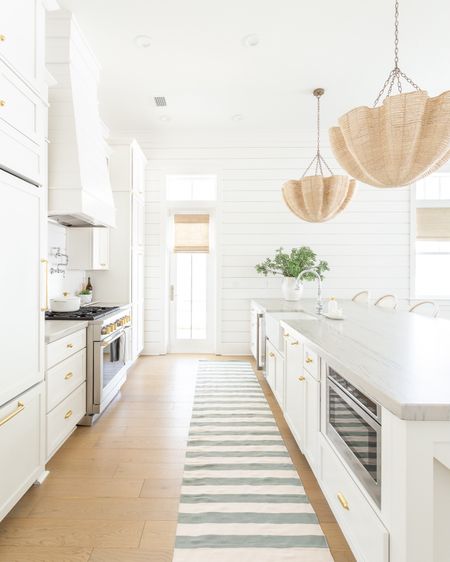 I added this favorite striped rug to our kitchen for spring because I’ve loved the look so much in other sizes in the past!. Also linking my scalloped pendant lights, swivel counter stools, woven Roman shades, faux greenery and white ceramic vase. Many items in our coastal kitchen are currently on sale! See our full spring home tour here: https://lifeonvirginiastreet.com/2024-spring-home-tour/.
.
#ltkhome #ltksalealert #ltkfindsunder50 #ltkfindsunder100 #ltkstyletip #ltkseasonal coastal decor, kitchen decor, spring decorating 

#LTKhome #LTKsalealert #LTKSeasonal