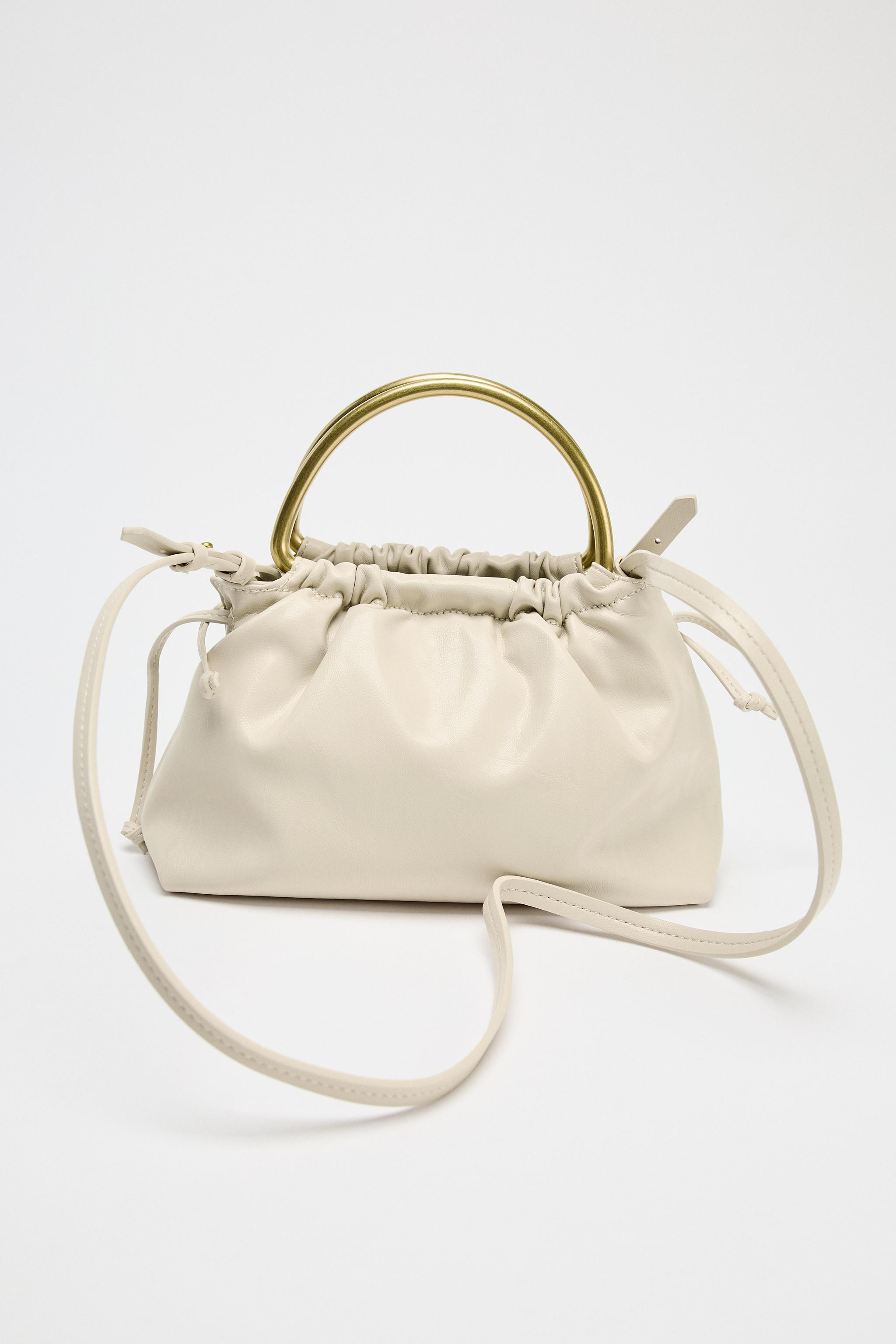 Mini soft-effect bucket bag. Double metal top handles and a removable crossbody strap. Interior z... | Zara US