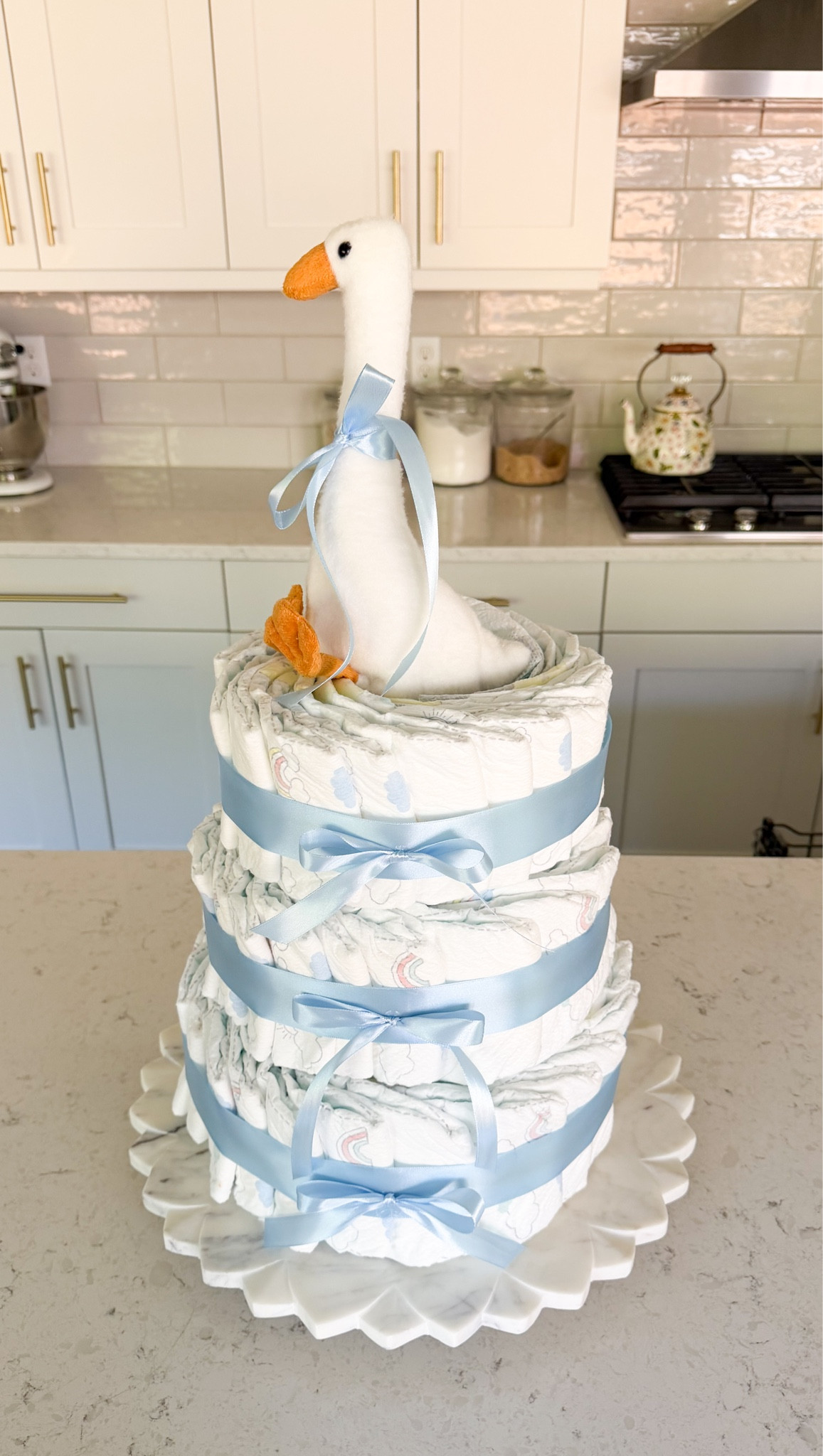 How I made this diaper cake without rolling any diapers! This was so fun to make for my friend’s Silly Goose is Almost on the Loose baby shower 💙🪿 #diapercake #babyshowerdecor

Silly goose themed diaper cake, Diaper, ribbon, rubber bands, round cake pan set, marble cake stand

#LTKsummer #LTKmaternity #LTKbaby