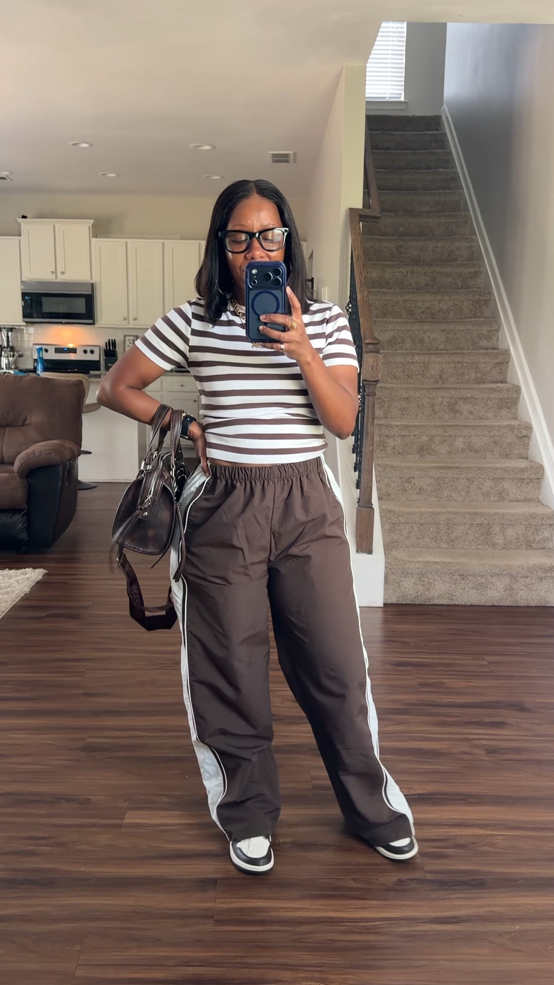 Brown and white simple outfit. 

I’m wearing a brown and white striped shirt with brown and white stripe track pants. I styled this outfit with a brown faux leather satchel and brown and white Jordan 1 sneakers

#LTKootd #LTKOver40 #LTKPetite
