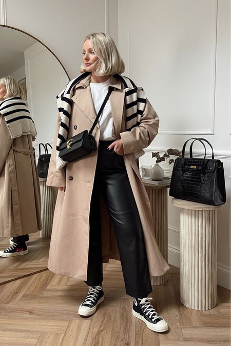 Styling leather trousers - white t shirt from COS, classic trench coat, striped jumper over the shoulders, converse & black coach crossbody bag

#LTKshoecrush #LTKitbag #LTKstyletip