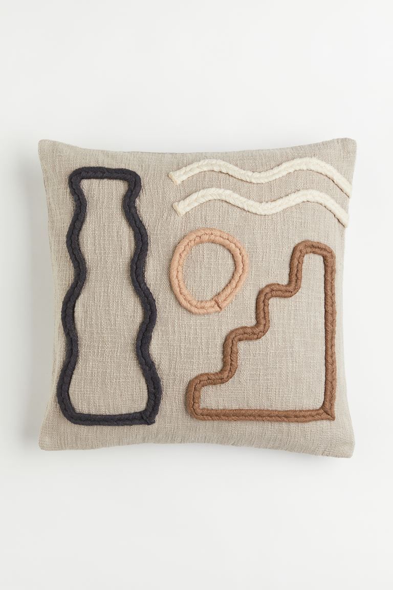Conscious choice  Cushion cover in woven cotton fabric. Braided appliqués at front, smooth back ... | H&M (US + CA)