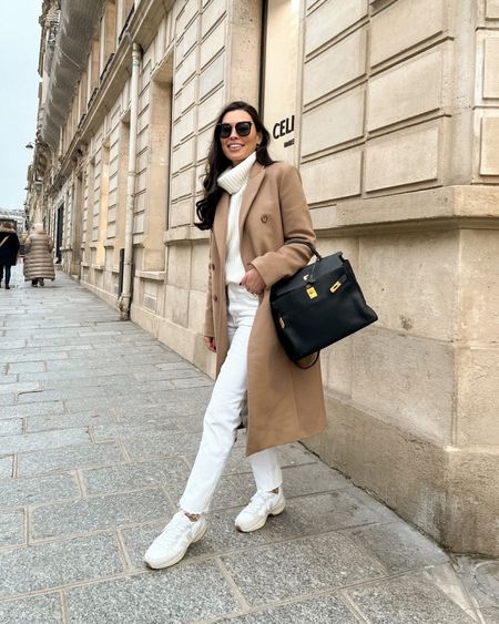 Kat Jamieson of With Love From Kat wears a neutral outfit. Cashmere turtleneck, cream jeans, sneakers, camel coat, Hermes bag, Paris style, neutral style. 

#LTKSeasonal #LTKstyletip #LTKshoecrush