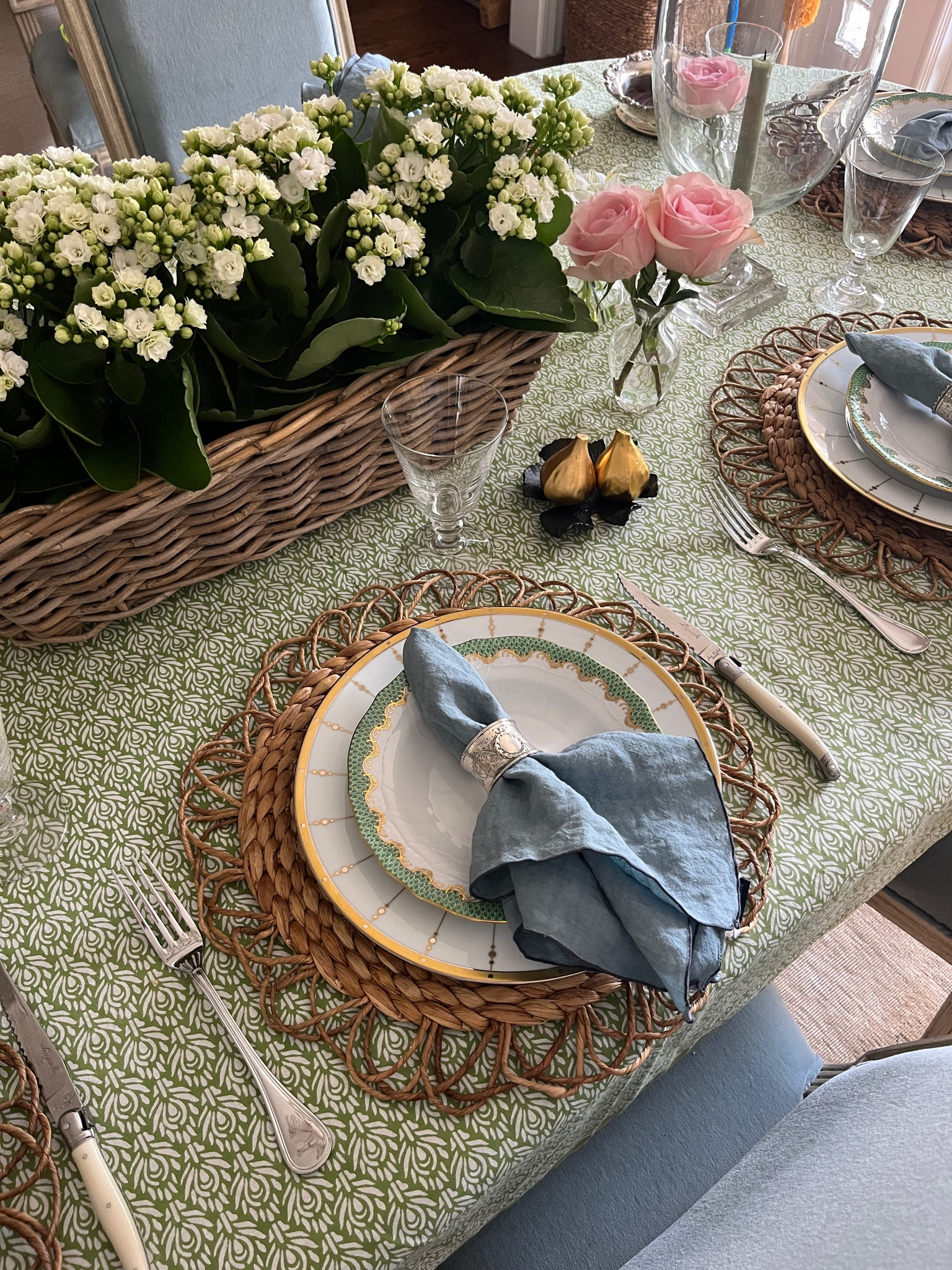 Spring feast! A long basket with small potted plants makes a great centerpiece, especially if you have a few days of hosting ahead of you! Here I put white kalanchoe in a basket from my favorite garden center shop. 

Napkin rings are mixed antique silver.  Tablecloth is old Amanda Lindroth and bud vases are Mrs. Alice. Similar linked. 

#LTKHome #LTKParties
