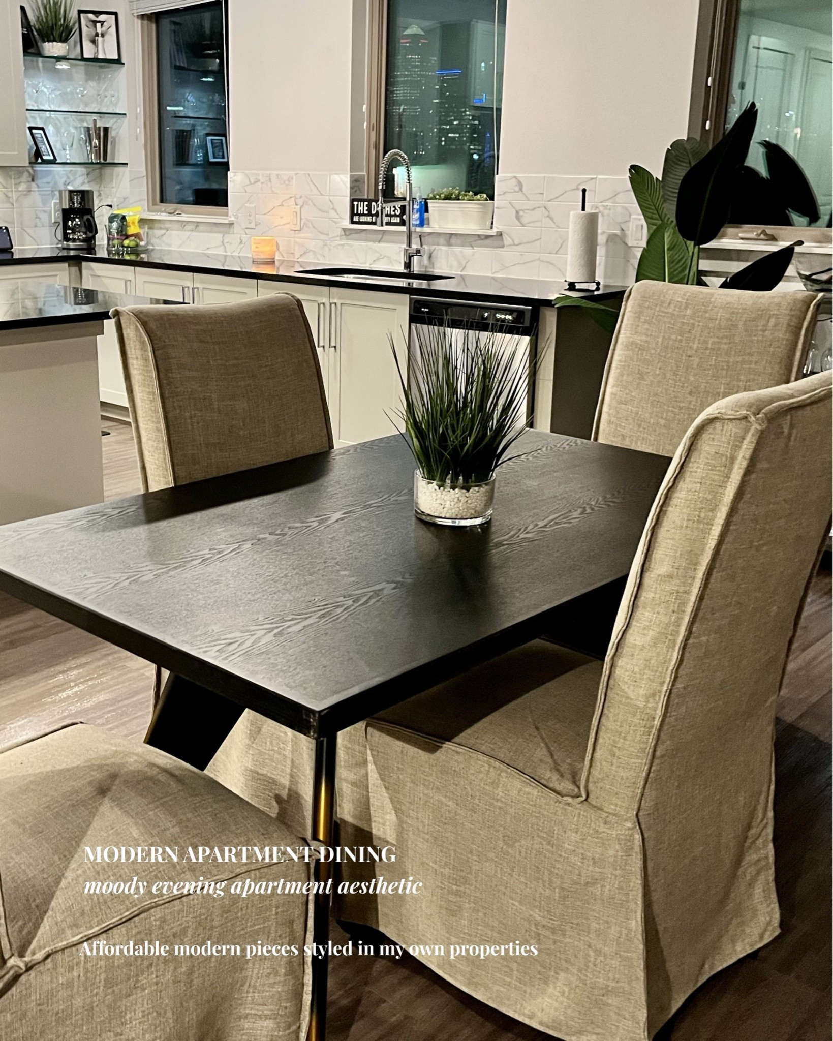Moody Evening Apartment Aesthetic

One of my favorite older apartment setups 🌃
I wanted this space to feel modern, elevated, cozy, and functional without spending luxury designer prices. The mix of black finishes, soft slipcovered dining chairs, warm lighting, and skyline views completely transformed the mood at night.

I slipcovered the dining chairs for a softer custom look, and since this is older content, I linked similar modern black pedestal dining tables along with the decor, lighting, bar cart, kitchen styling pieces, and apartment aesthetic finds.

Affordable modern pieces styled in my own properties.

#LTKHome #ApartmentDecor #ModernApartment #MoodyHome #DiningRoomDecor #ModernDiningRoom #ApartmentAesthetic #BlackAndWhiteDecor #NeutralHomeDecor #ModernHomeStyle #AffordableHomeDecor #ContemporaryHome #WayfairFinds #AmazonHome #WalmartHome #HomeStyling #InteriorStyling #SmallSpaceDecor #RentalDecor #MoodyAesthetic

#LTKOver40 #LTKHome