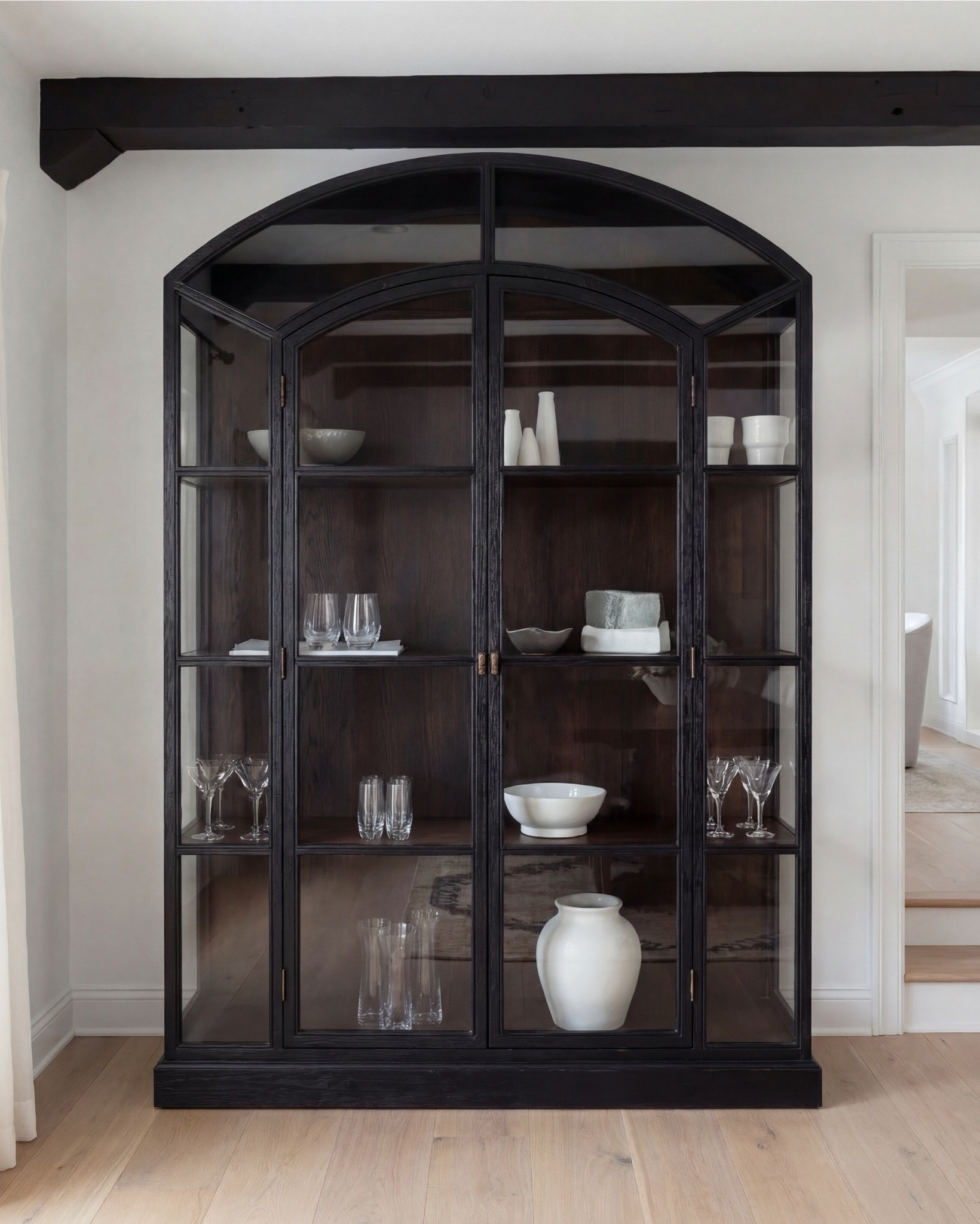 Shop the Look:
• Dark wood pedestal dining table
• Cream upholstered dining chairs with light wood legs
• Large neutral area rug with charcoal medallion pattern
• Black arched display cabinet / hutch
• Light wood sideboard / buffet cabinet
• Large ceramic floor vase (neutral tone)
• White ceramic bowl with white florals (peonies or roses)
• Pink faux cherry blossom stems in white vase
• Neutral ceramic table lamp with white shade
• Tall brass wall sconces with glass detailing
• Framed botanical artwork (set of four)
• Dark abstract wall art (large statement piece)
• White decorative vases (assorted sizes)
• Light linen curtains

#LTKhome #LTKsale #LTKstyletip