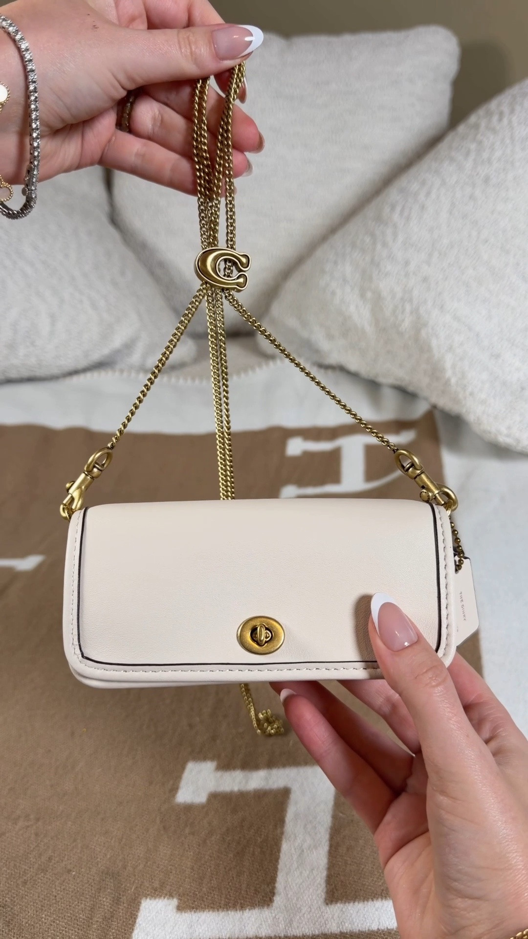 The tiniest Coach bag ever also comes with the cutest strap (and it’s available on Amazon)! 😱 she’s currently out of stock but I linked her so you can check in for restocks 🤍 Comment SHOP & I’ll dm you the link 🤍

This is the Coach Dinky 14 in white and she comes with the prettiest adjustable chain strap. You can wear the Dinky 14 as a belt bag, shoulder bag, or crossbody bag. Tot can also make it a little pouch or wallet and use the chain to decorate other bags. The chain is my favorite part as well as the little turn lock 😍