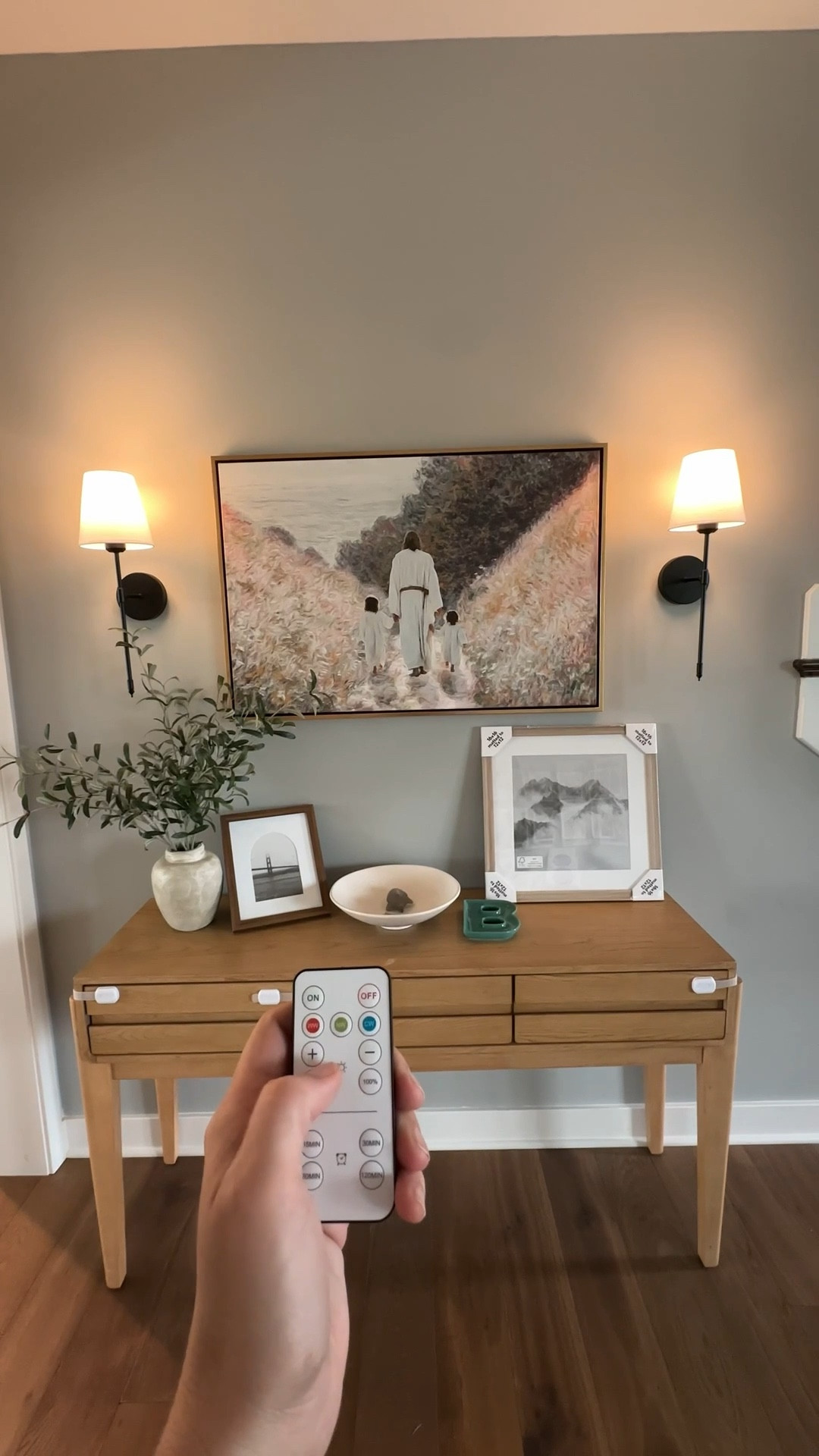 My favorite spot in our house that feels the most put together since moving in lol. These sconces aren’t wired in and the bulbs charge. It’s such an easy way to add a little extra cozy to our entryway. And I love this faux olive plant so much. The frames are TBD but I’m thinking of adding some kids crafts to them.🥹🤍 

#LTKFindsUnder50 #LTKFindsUnder100 #LTKHome