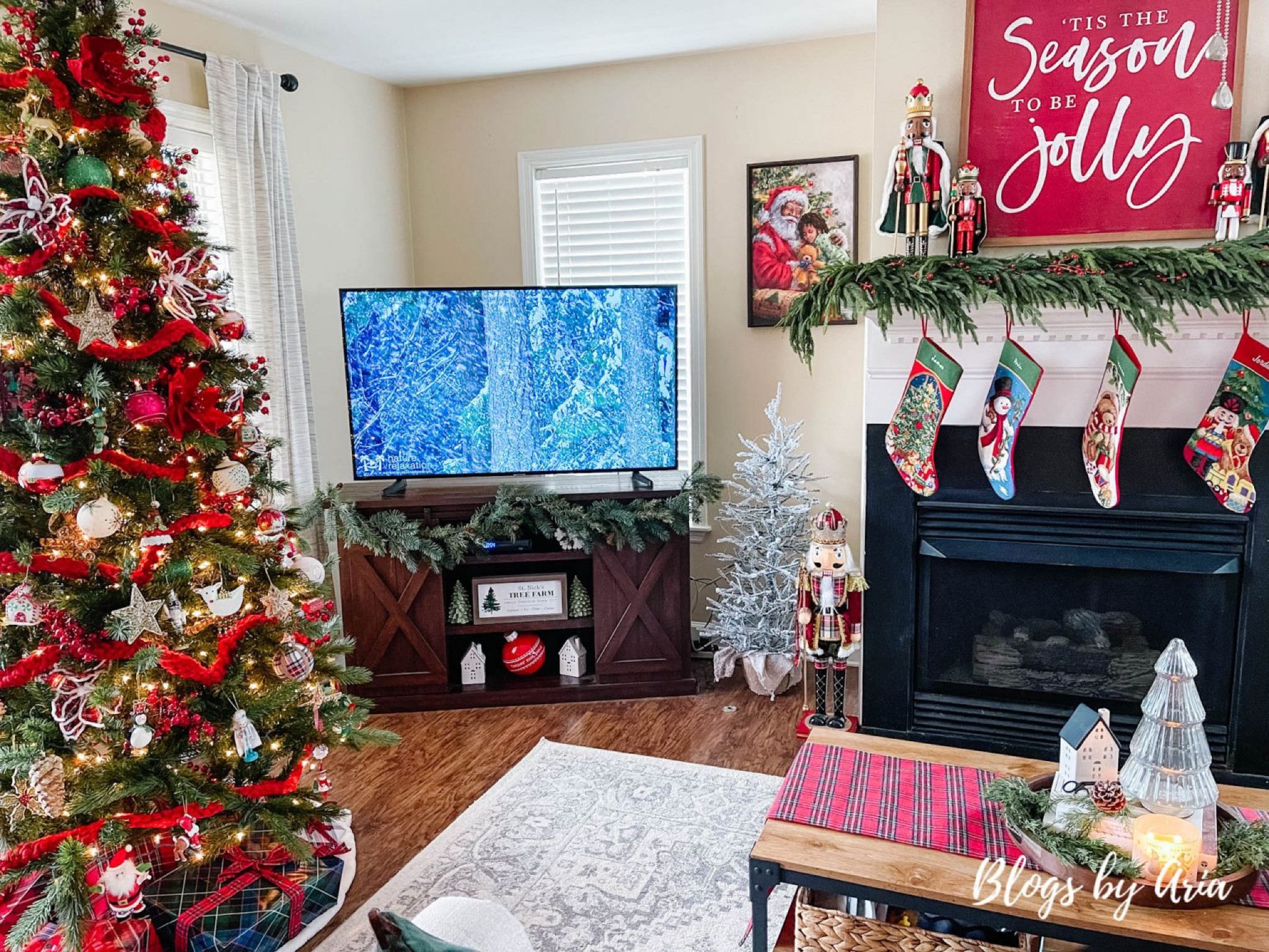 Christmas living room. Barn door tv stand. Flocked accent tree. Embroidered stockings. Area rug. Christmas sign. Pine garland  

#LTKhome #LTKSeasonal #LTKHoliday
