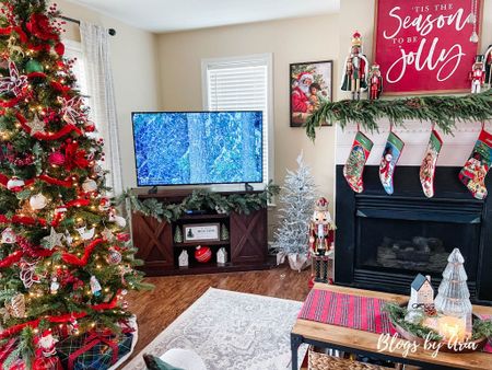 Christmas living room. Barn door tv stand. Flocked accent tree. Embroidered stockings. Area rug. Christmas sign. Pine garland  

#LTKhome #LTKSeasonal #LTKHoliday