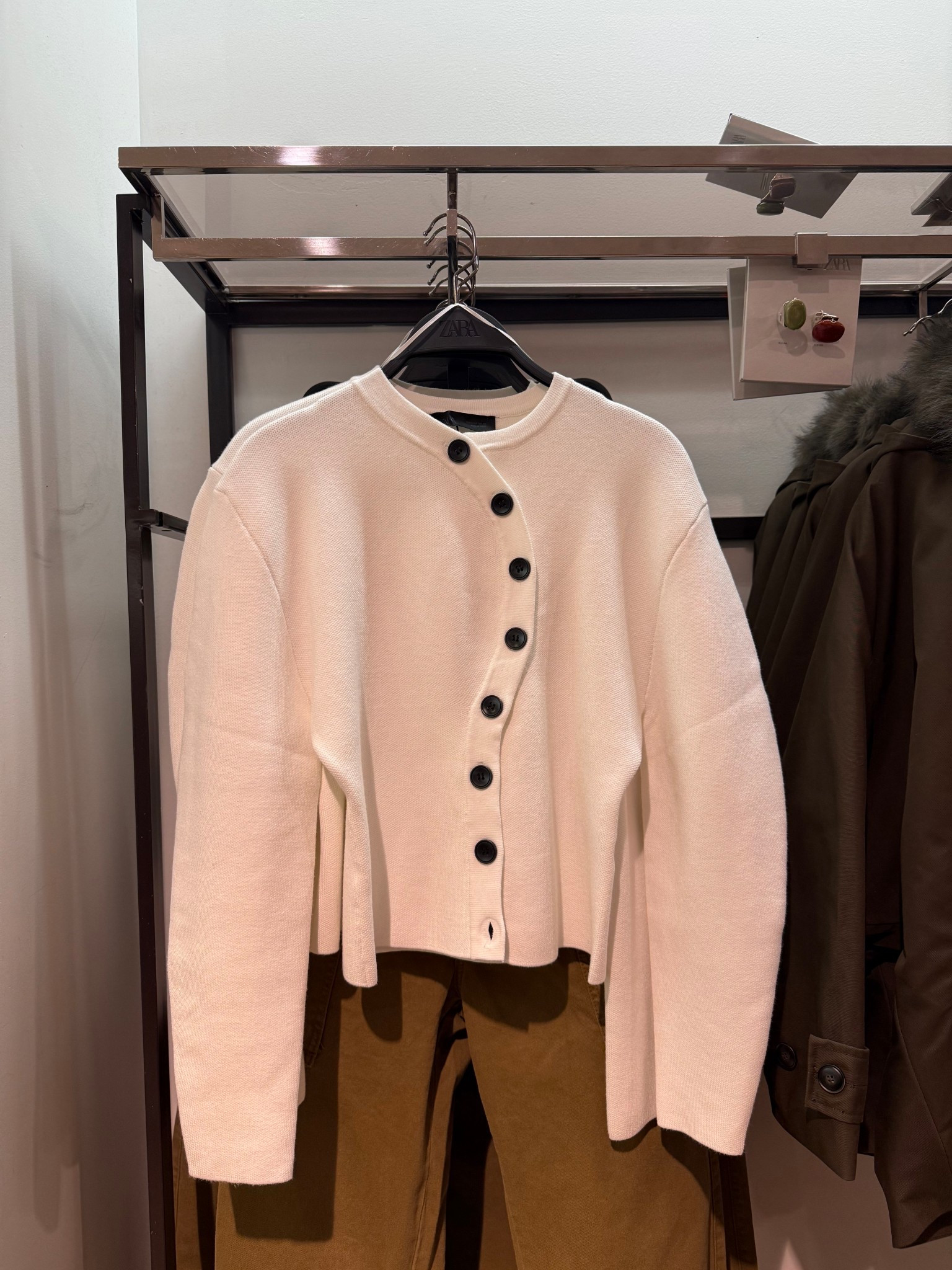 This sweater cardigan top is also pretty. I love how the buttons are placed in wave. Great for work and beyond the office  

#LTKWorkwear #LTKNYFW