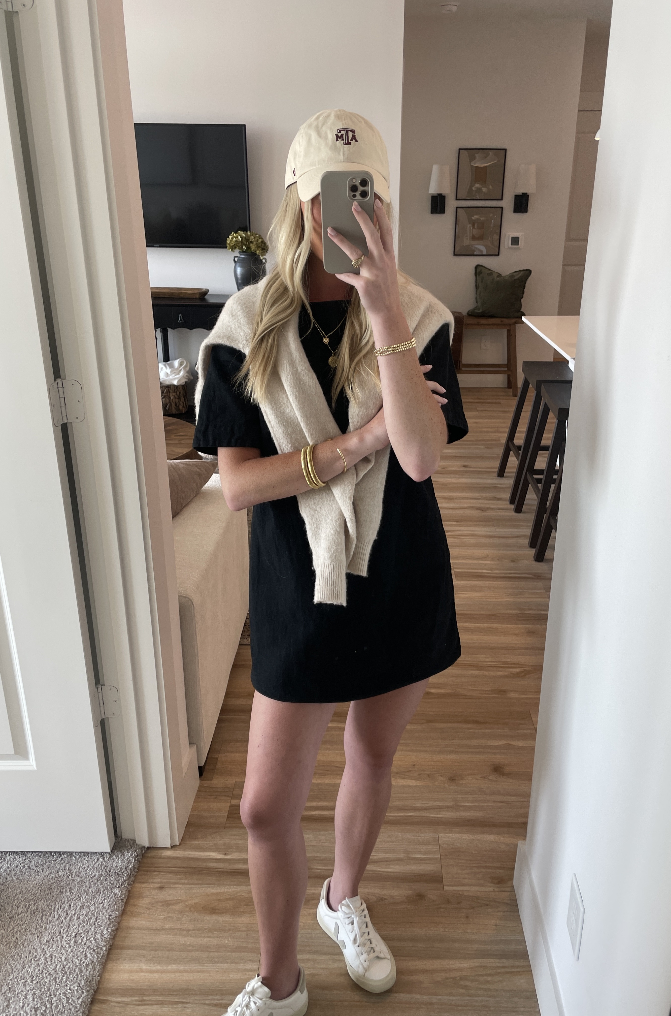 Black mini dress outfit idea
trucker hat/ casual outfit/ mini dress/ gameday/ sneakers 

 #LTKSeasonal #LTKFindsUnder50 #LTKStyleTip