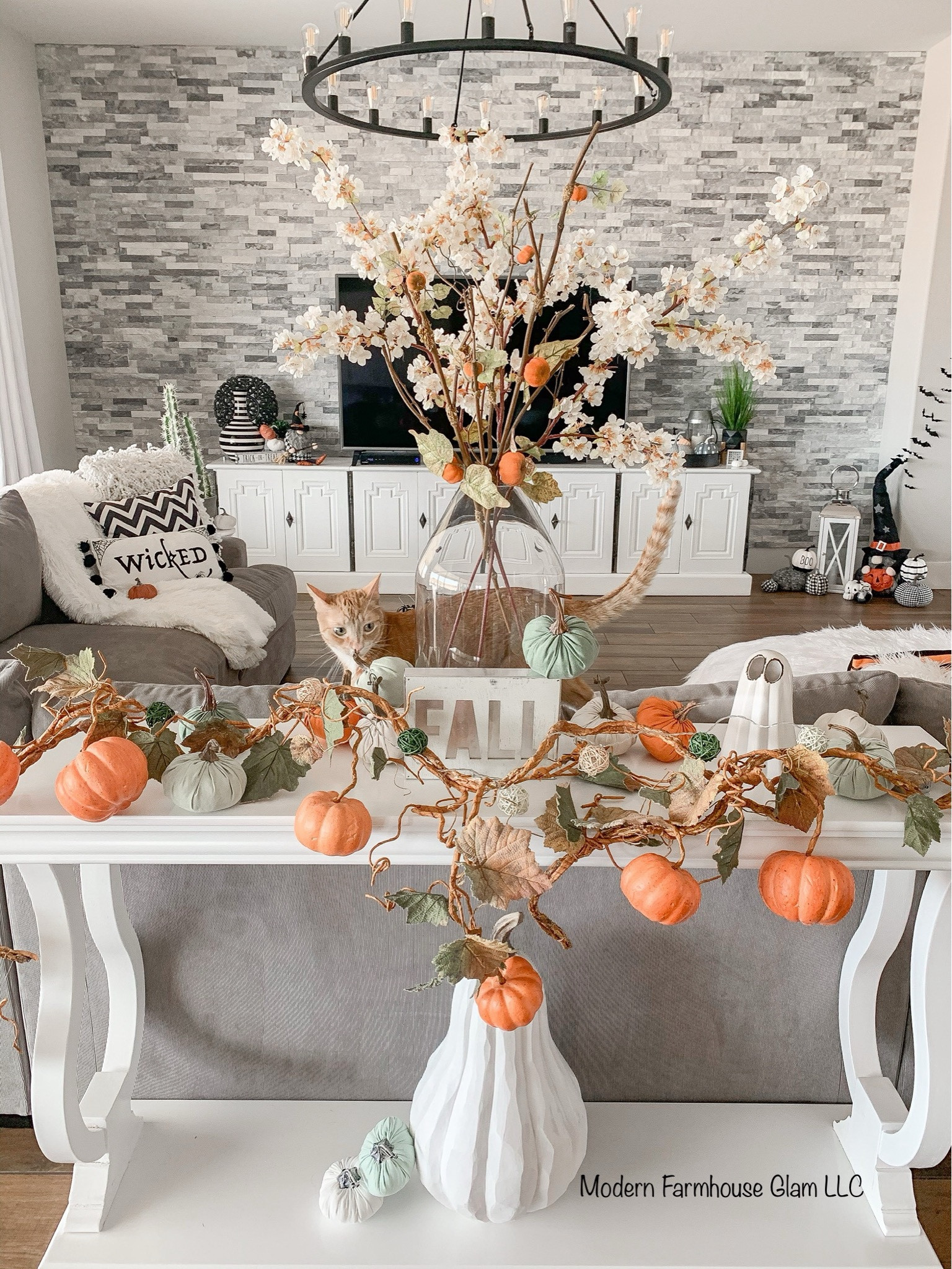 Fall decorations, pumpkin garland, gray sectional sofa couch, large media Consol tables, wagon wheel iron chandelier, Halloween, autumn, home decor, furniture, living room, Modern Farmhouse Glam

#LTKHome #LTKSeasonal