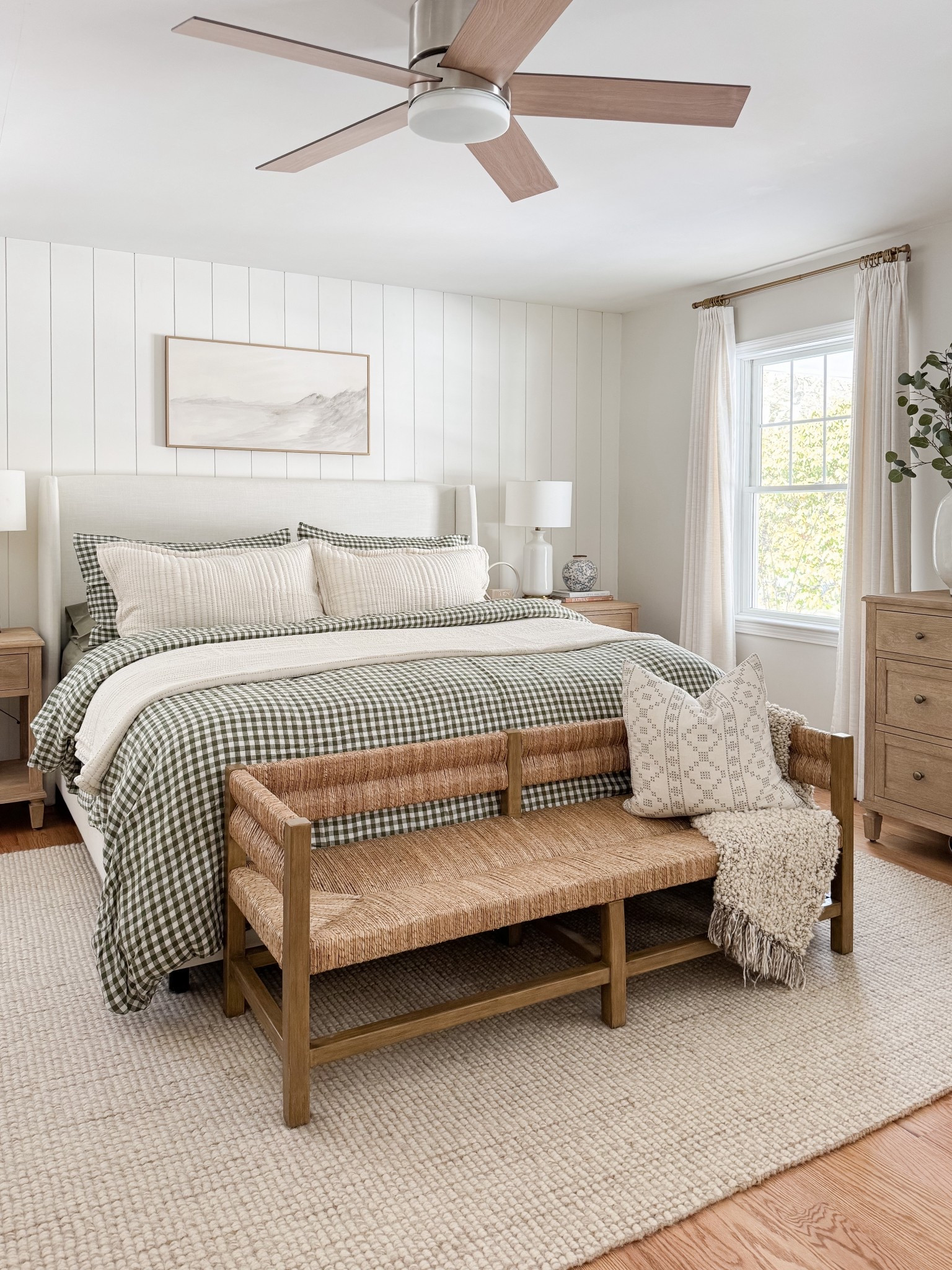 Neutral coastal bedroom with gingham bedding, layered throw blankets, textured knit coverlet, and soft patterned pillows. Light wood nightstands and white table lamps create a calm, layered spring bedroom look. 
gingham bedding, neutral bedroom decor, layered bedding, spring bedding, coastal bedroom, throw blanket, knit coverlet, patterned pillows, light wood nightstands, white table lamps, cozy bedroom, serene bedroom style, sherri calnan home

#LTKHome