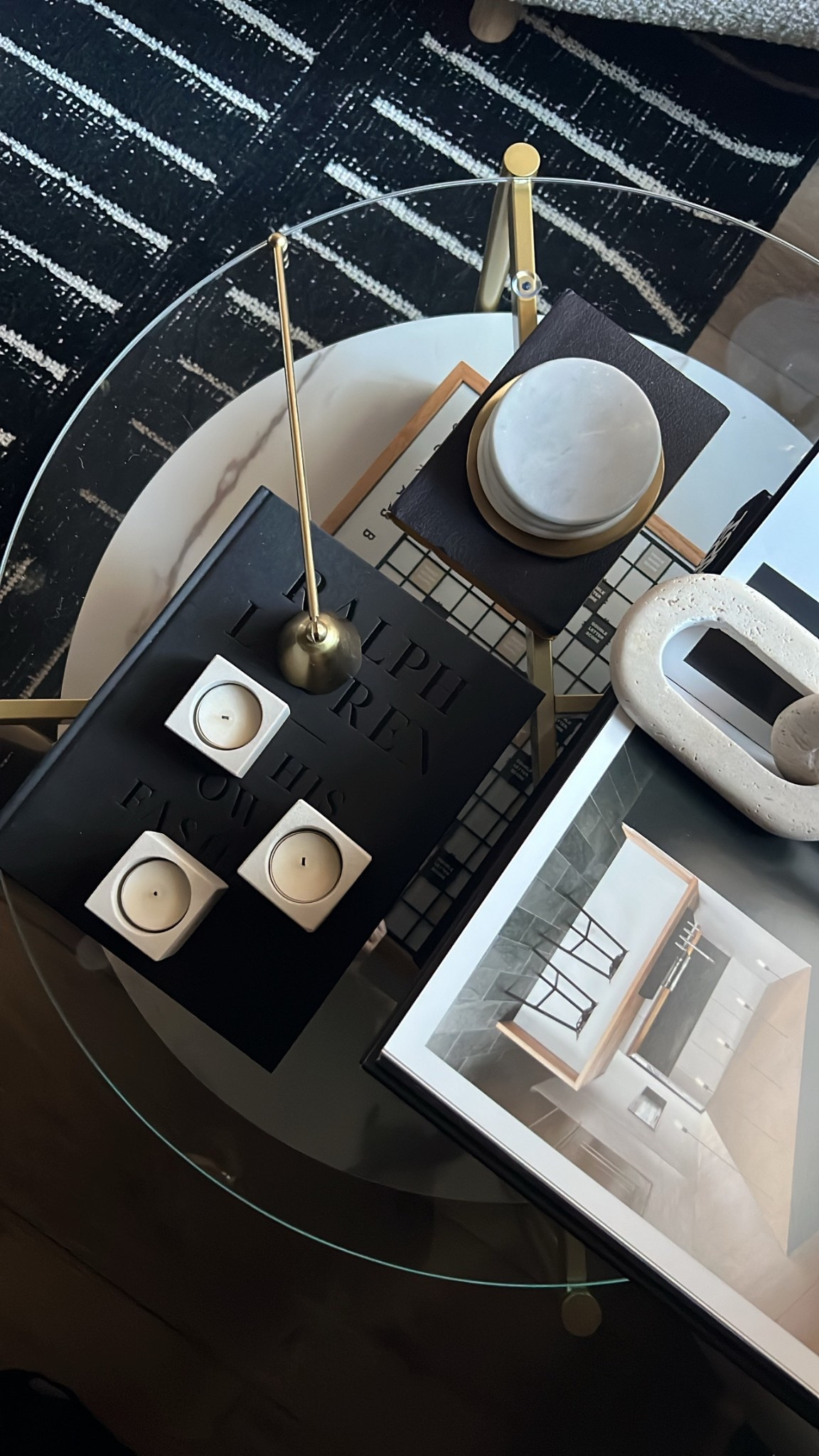 I styled this table with an organic modern vibe using coffee table books, sandstone candles and a tray of coasters! Black and white coffee table books, glass, round glass, coffee, coaster set