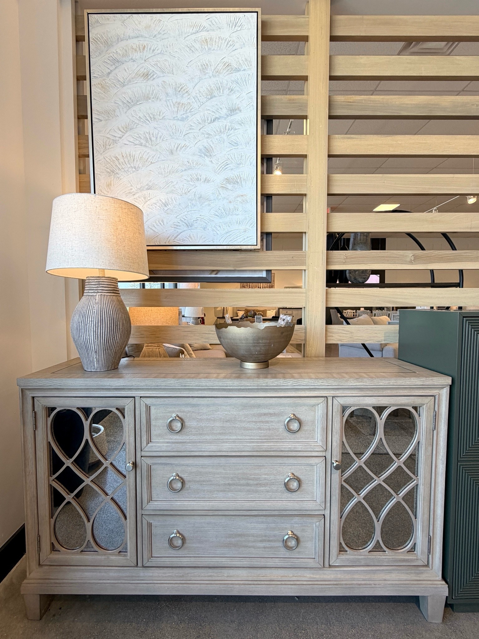 Elegant sideboard with beautiful antiqued mirror detailing! 🤩 The Jorlaina Dining Server from Ashley Furniture combines a rich gray wood finish, decorative fretwork, and classic molding details for a look that feels refined and timeless. ✨ The spacious drawers and cabinets offer plenty of storage while adding a sophisticated focal point to a dining room or entryway. 🩶 Such a gorgeous furniture find. Linked it here! @Ashley #Sideboard #Credenza #DiningRoomFurniture

#LTKHome #LTKSaleAlert
