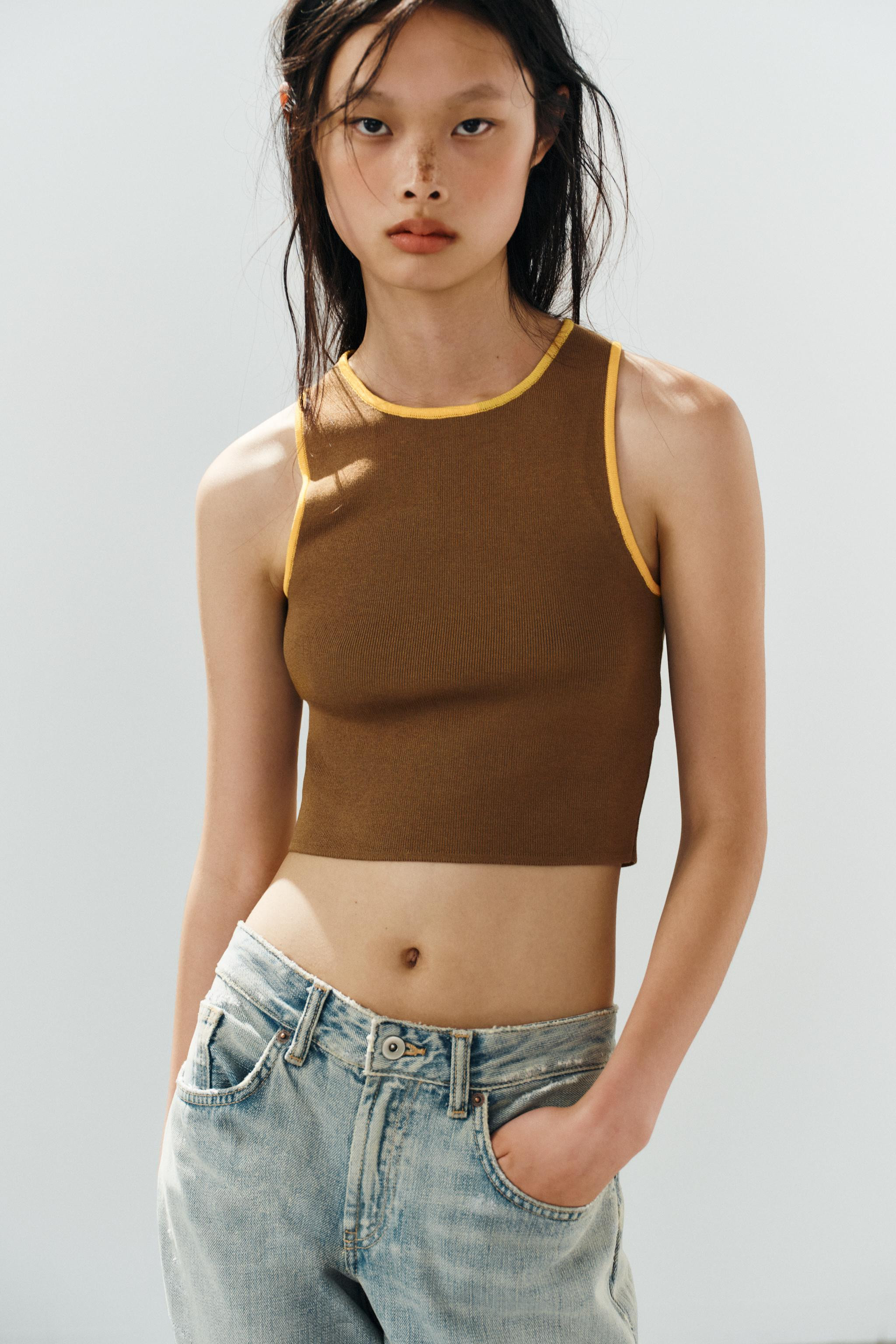 Cropped top with a round neck and sleeveless design. Features contrasting trim details. | Zara US