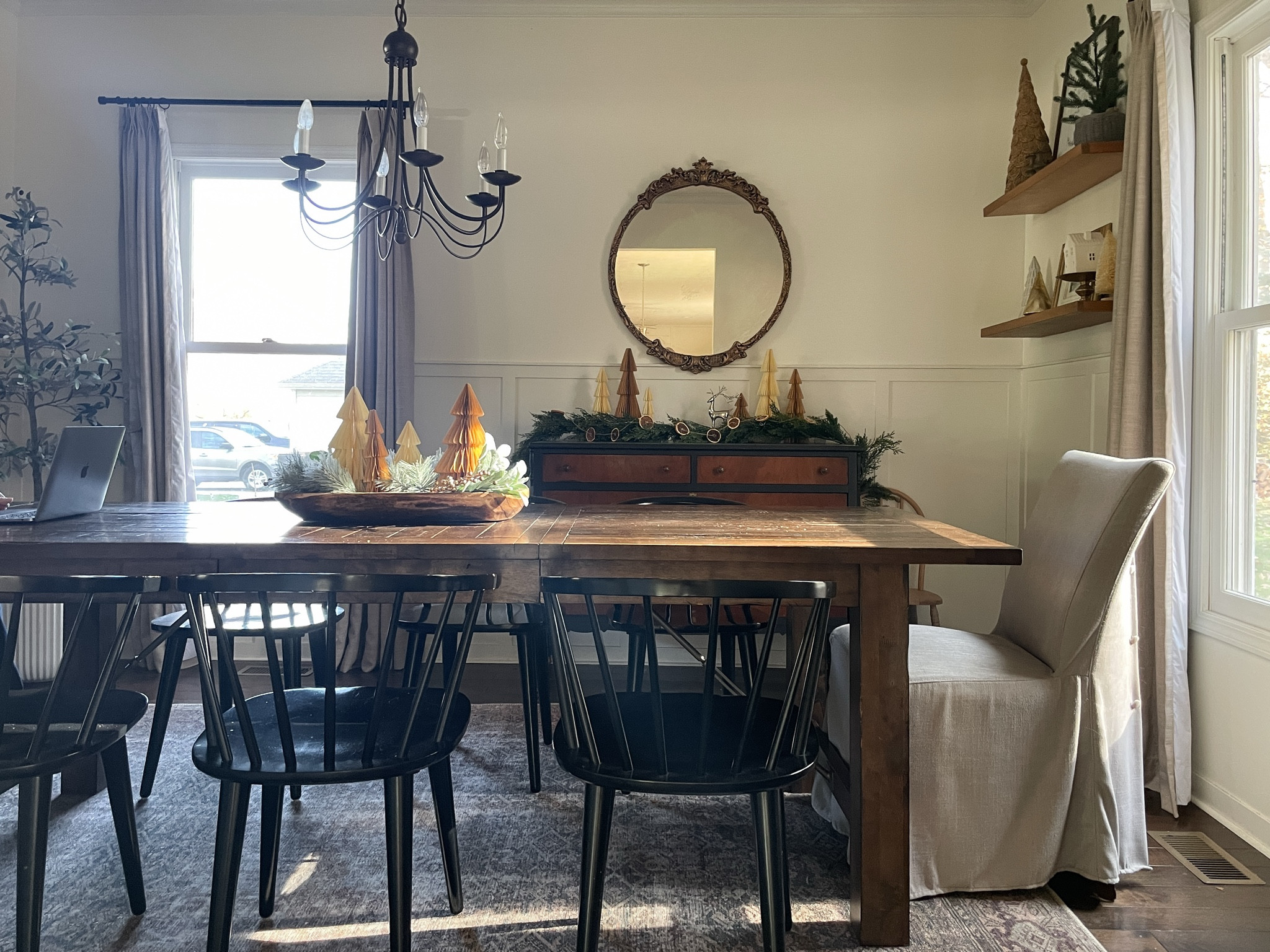 Our dining room decorated for Christmas.  

According paper trees.  World Market dining table.  Black modern dining chairs.  Loloi area rug.  Ornate gold mirror.  Garland.  #LTKHoliday 

#LTKSeasonal #LTKHome