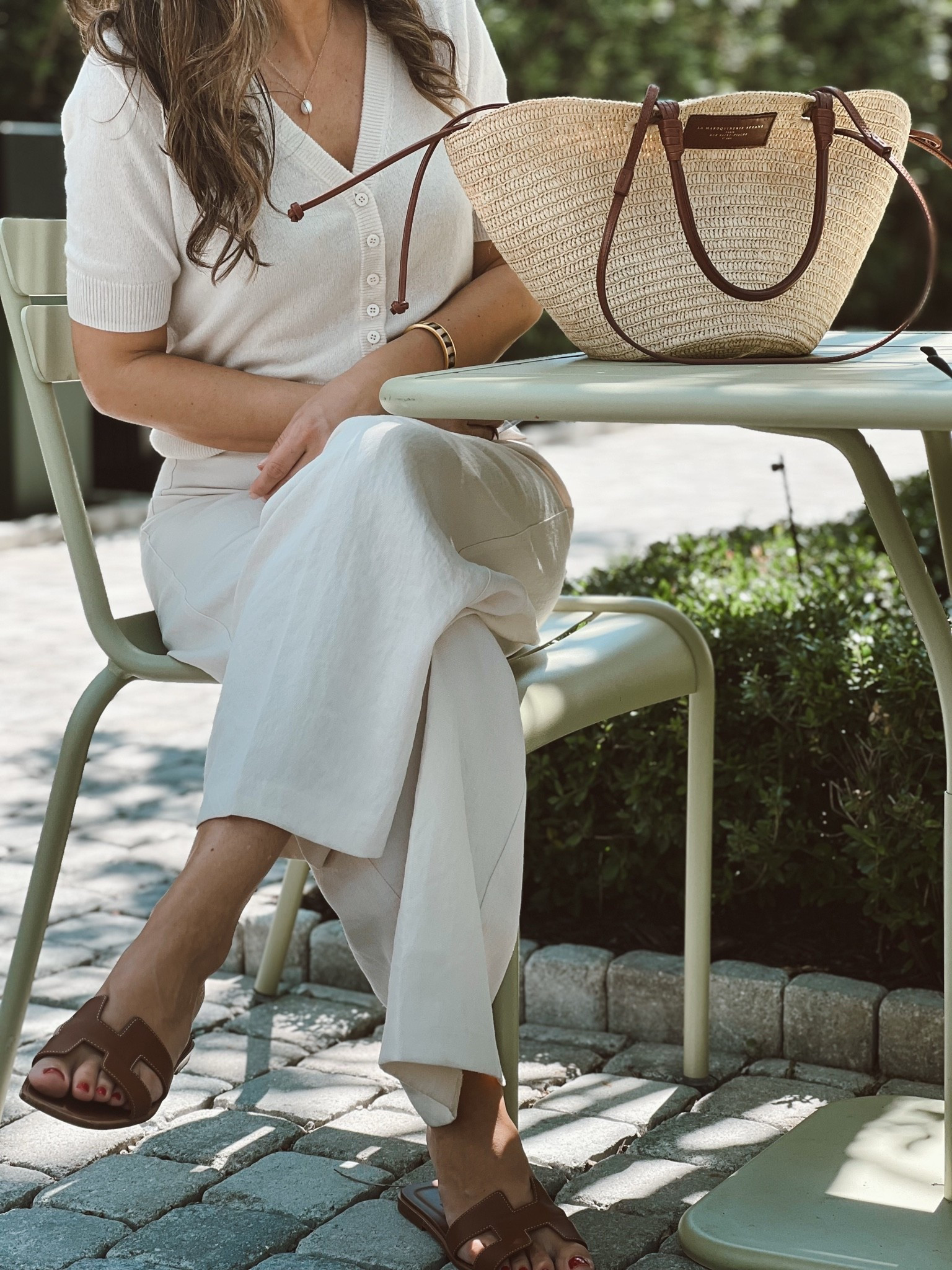Lightweight cashmere sweater in small.  A wardrobe staple!
The Sezane bag is still a summer favorite 3rd year in a row.  
Linen or linen blend pants are my go-to this time of the year for an effortlessly polished outfit. 
Slides are Hermes - linked gorgeous alternatives.