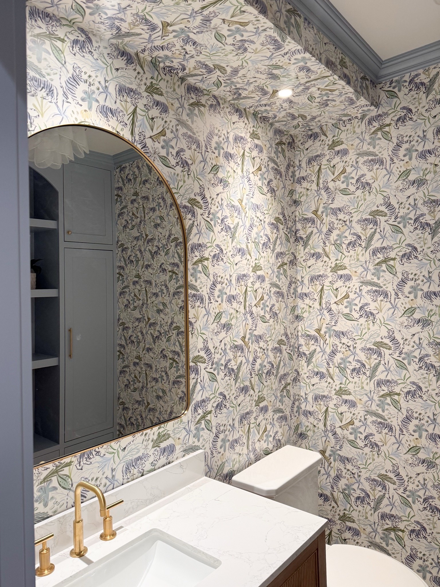 Small spaces are where I love to have the most fun with design. This client powder room came together with bold tiger wallpaper, warm wood, brass accents and soft blue tones that make every detail feel intentional. Linking the wallpaper, vanity, mirror and more from the space here.

powder room decor, tiger wallpaper, bathroom vanity, brass bathroom fixtures, blue bathroom, small bathroom design, statement wallpaper, bathroom mirror, interior design finds, Girl on the Hudson

#LTKHome #LTKSeasonal #LTKmorningroutine